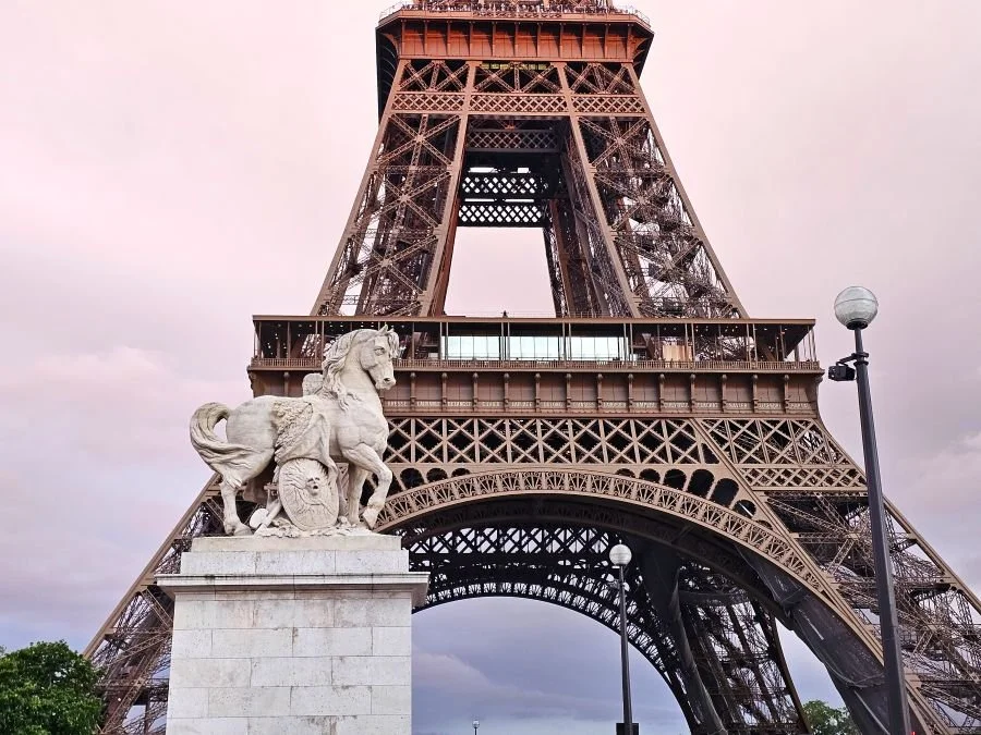The Eiffel Tower in Paris under a sunset sky