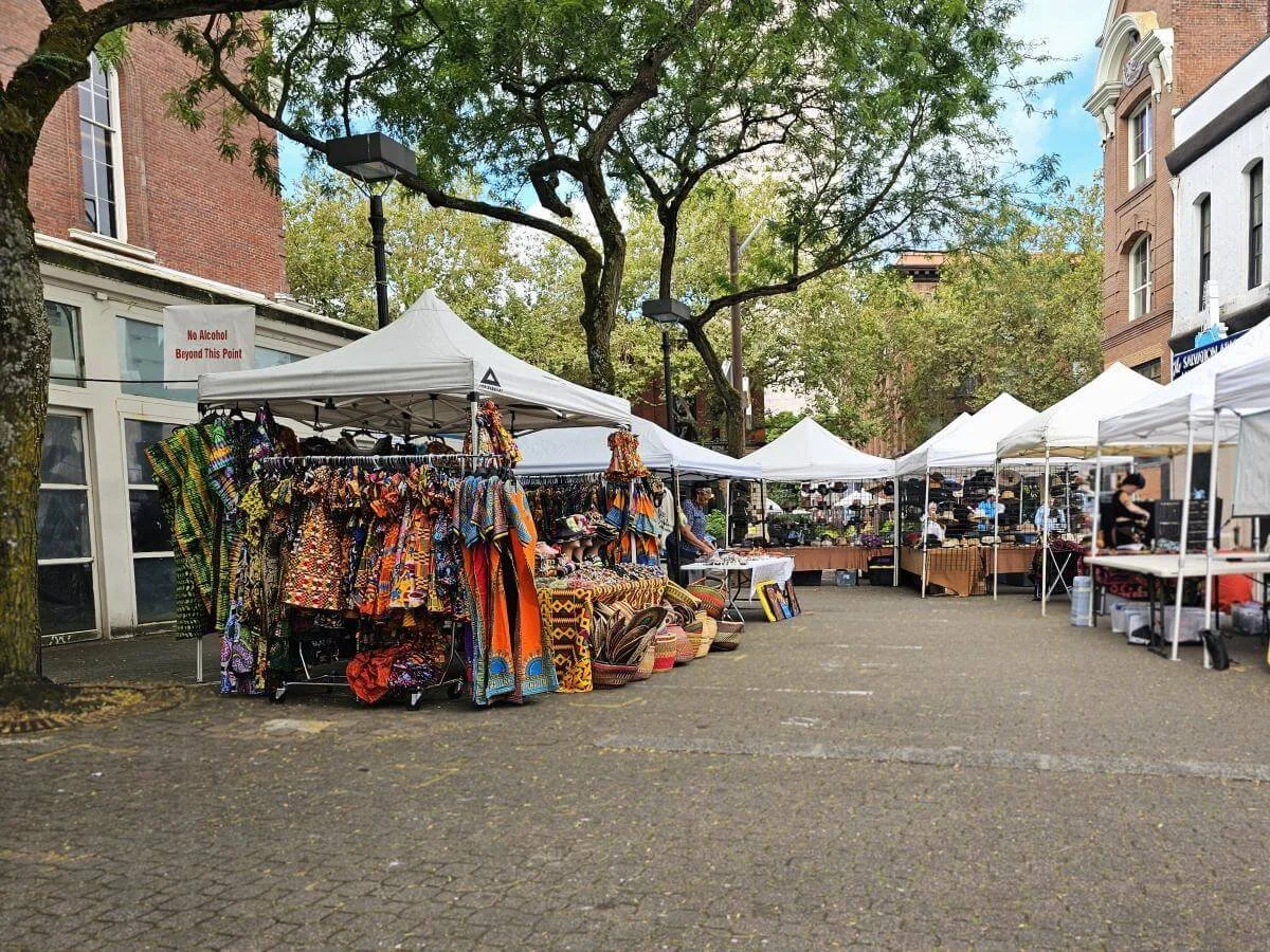 White tents with merchandise underneath at the Portland Saturday Market