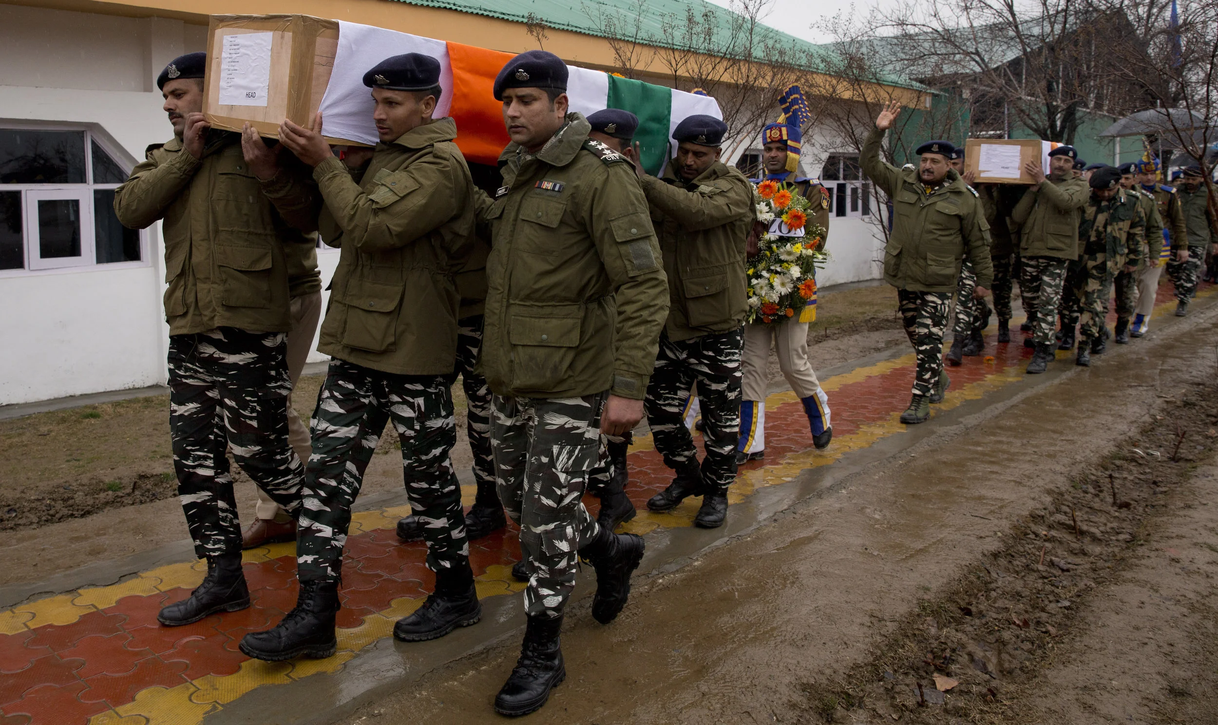 Indian paramilitaries carry the coffins of their fellow soldiers killed in gunfire in Indian-controlled Kashmir ( Image )