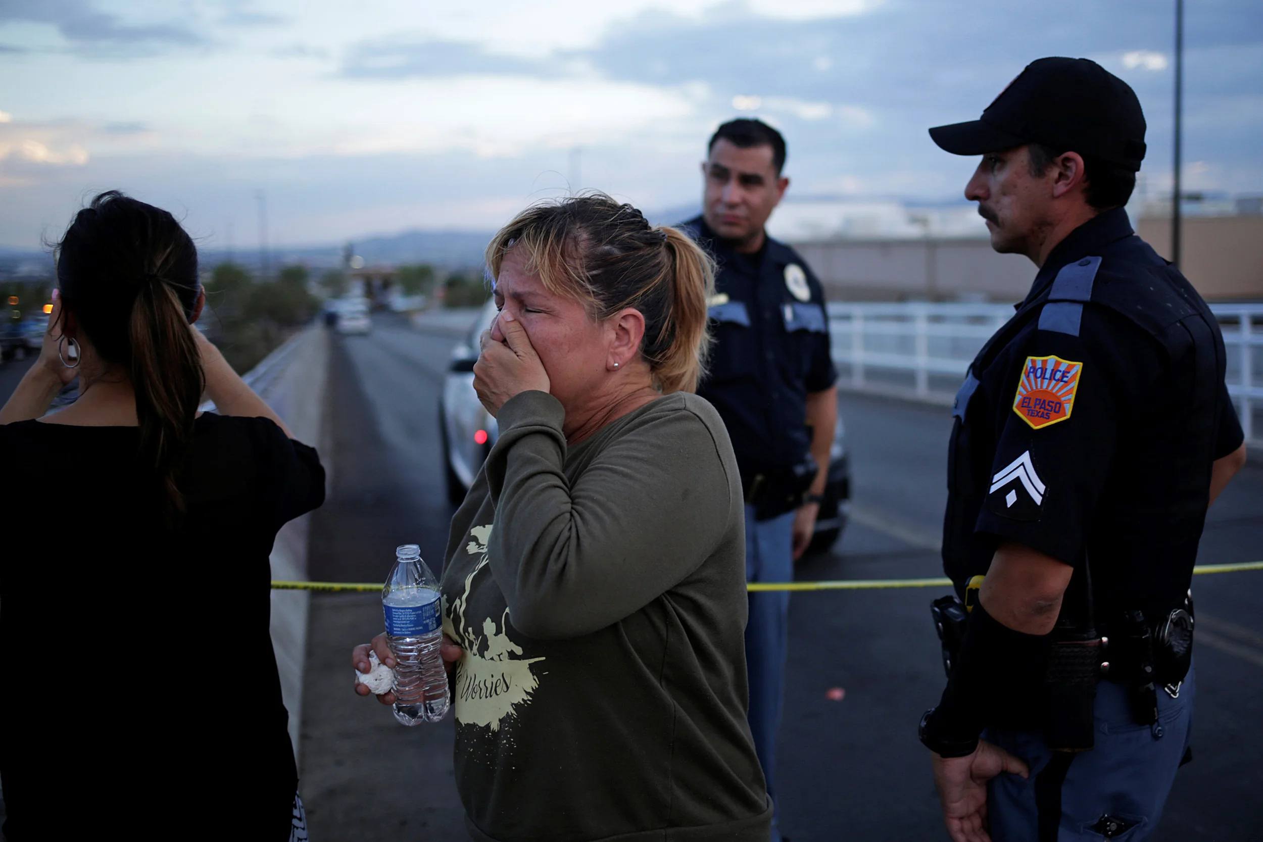 Onlookers stand outside an El Paso Walmart, where a gunman killed 22 shoppers in August ( Image )