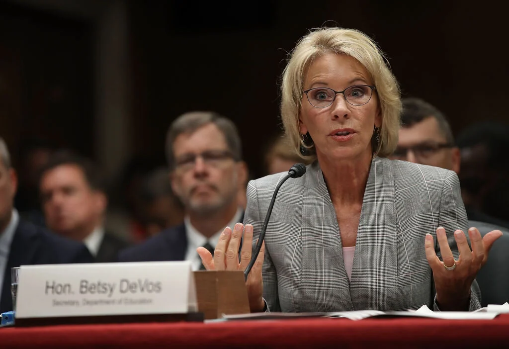 The U.S. Department of Education, headed by Betsy DeVos, threatened to withdraw funding for the consortium (Image)