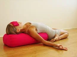 Supported Saddle pose to help lengthen not only the quads and posas, but invite opening in the ascending and descending colon.