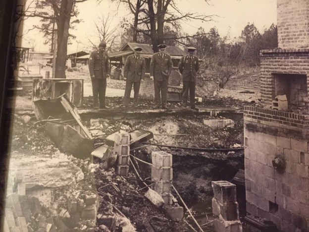 Four of Vernon Dahmer’s sons, who were serving in the armed forces at the time of his murder, observe the family home burned to the ground. (Six of his seven sons served 78 years in the military). Photo by Chris McNair , courtesy of Jerry Mitchell.