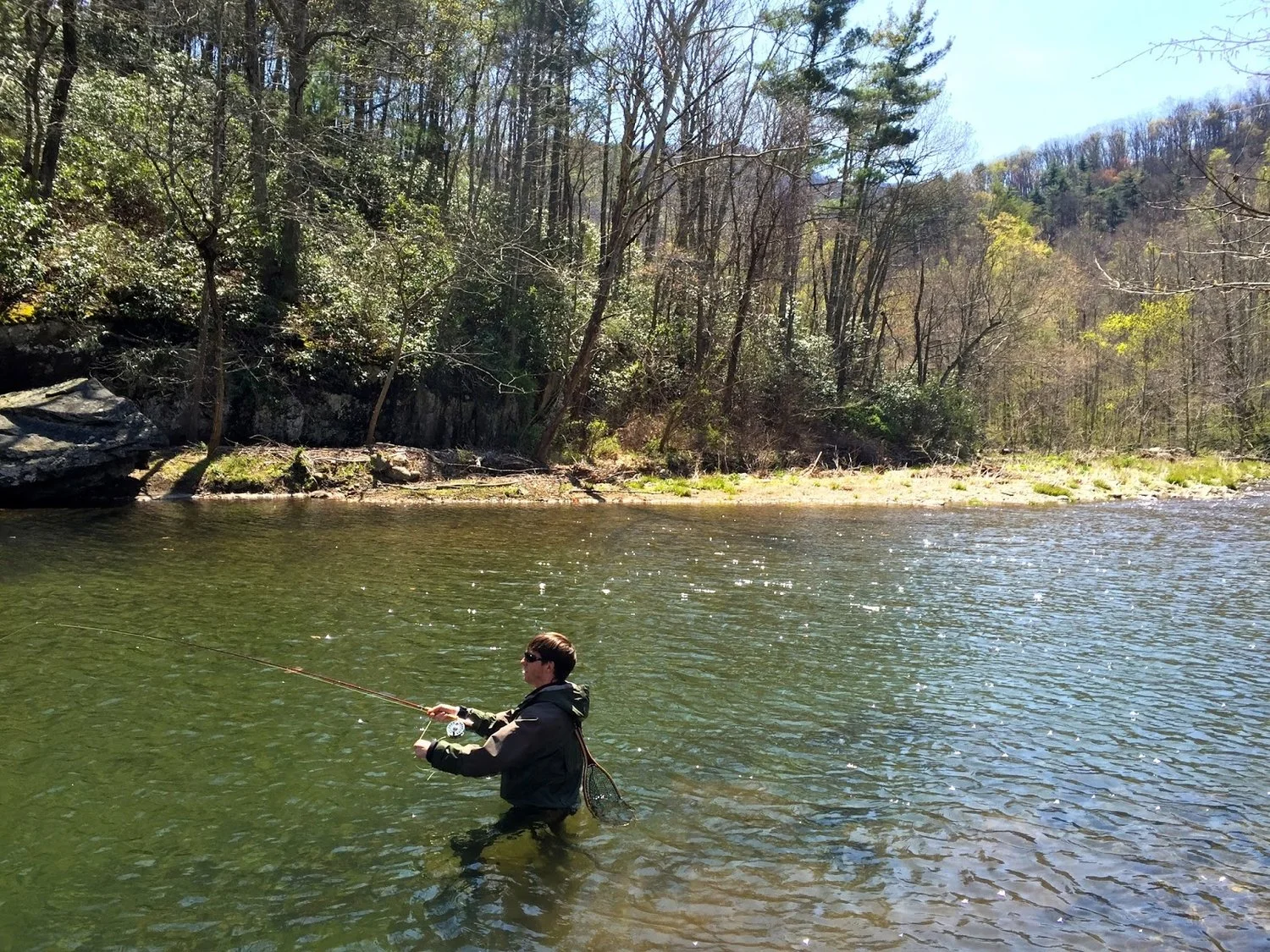 Michael in waist-deep water wearing waders, wading boots and a wading jacket.