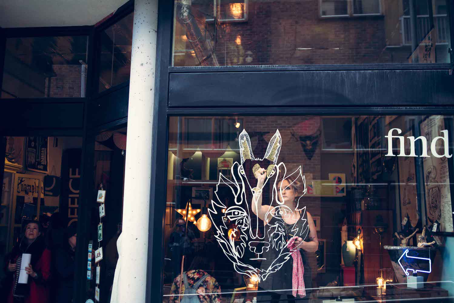 Artist Salty Philip creates a window mural at Find.