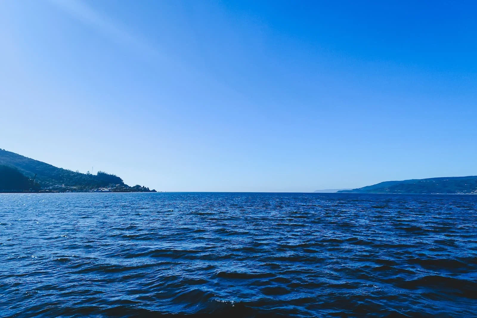 Panoramic view across the bay from the front outdoor seating area of the ferry.