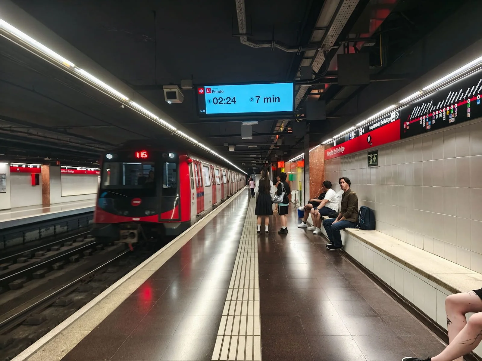 Barcelona Metro train arriving at an underground station platform