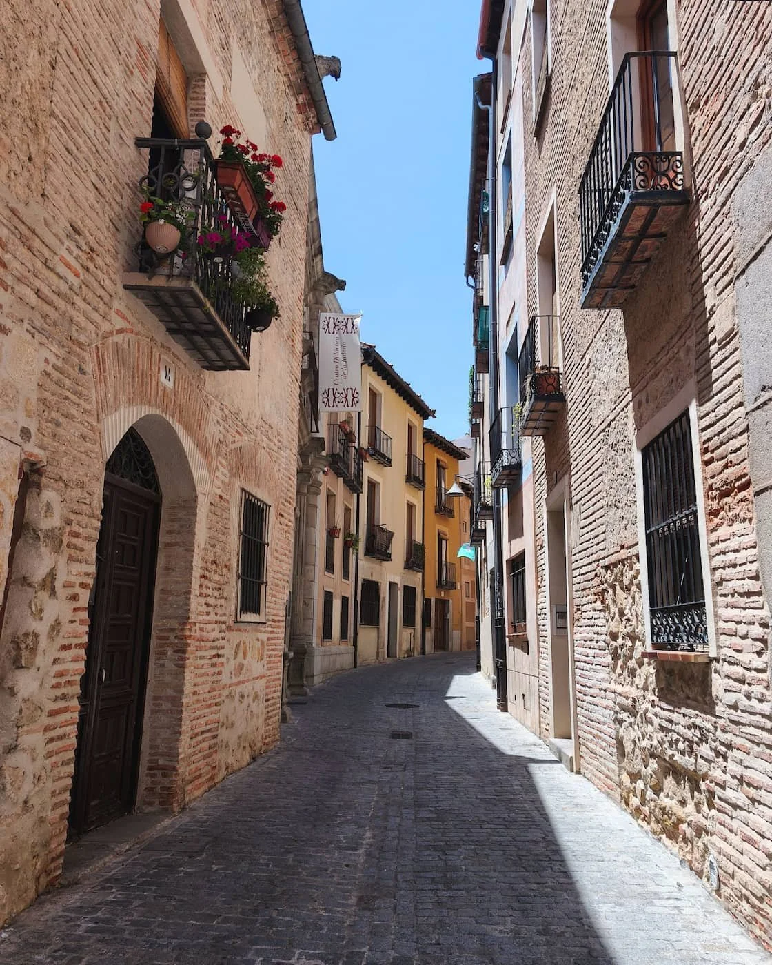 Narrow stone street in Segovia’s Jewish Quarter on the route toward the Alcázar.
