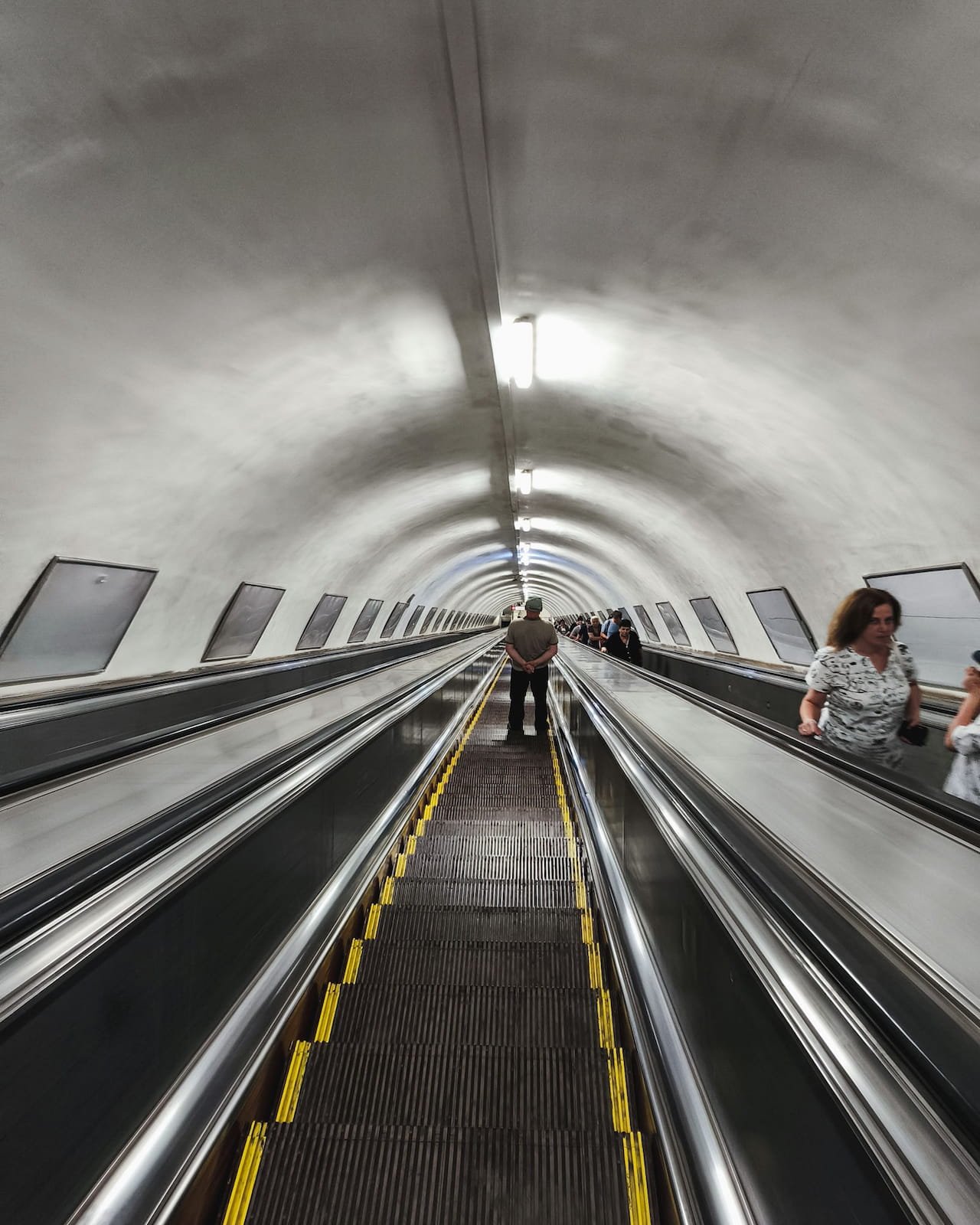 Long escalator descending into a deep Tbilisi Metro station