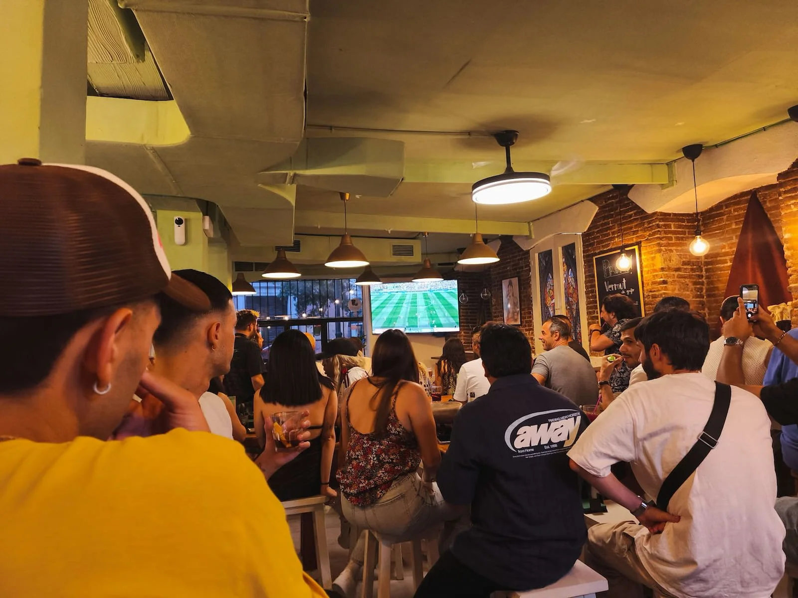 People watching a World Cup match at a busy bar in Madrid.