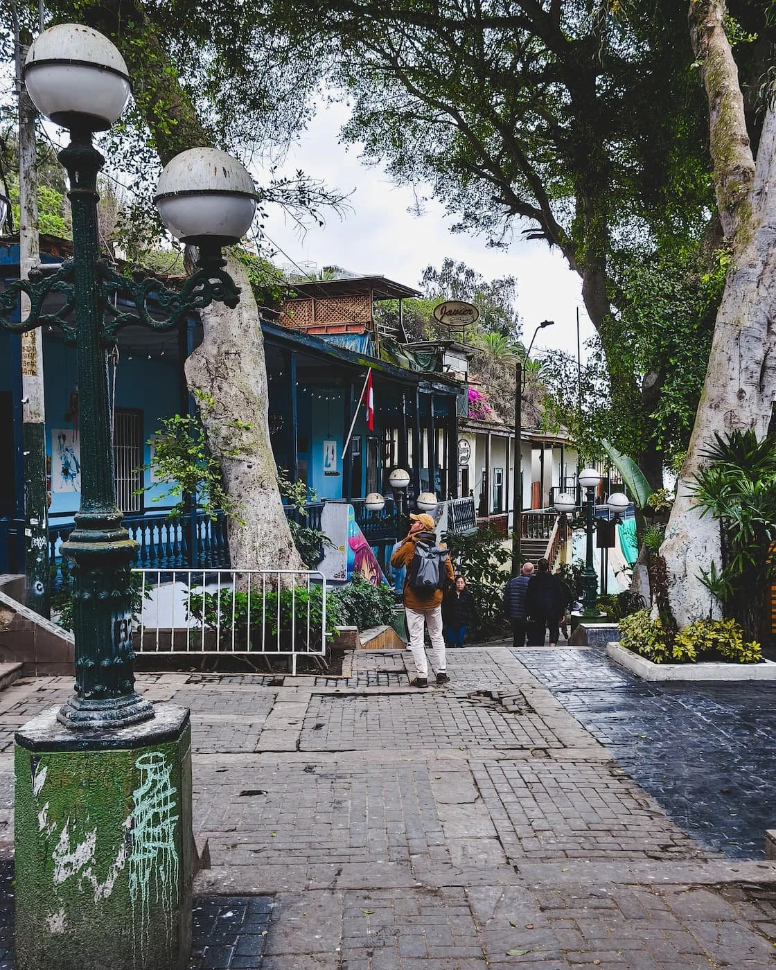 Bajada de los Baños, with colorful wooden buildings lining the path.