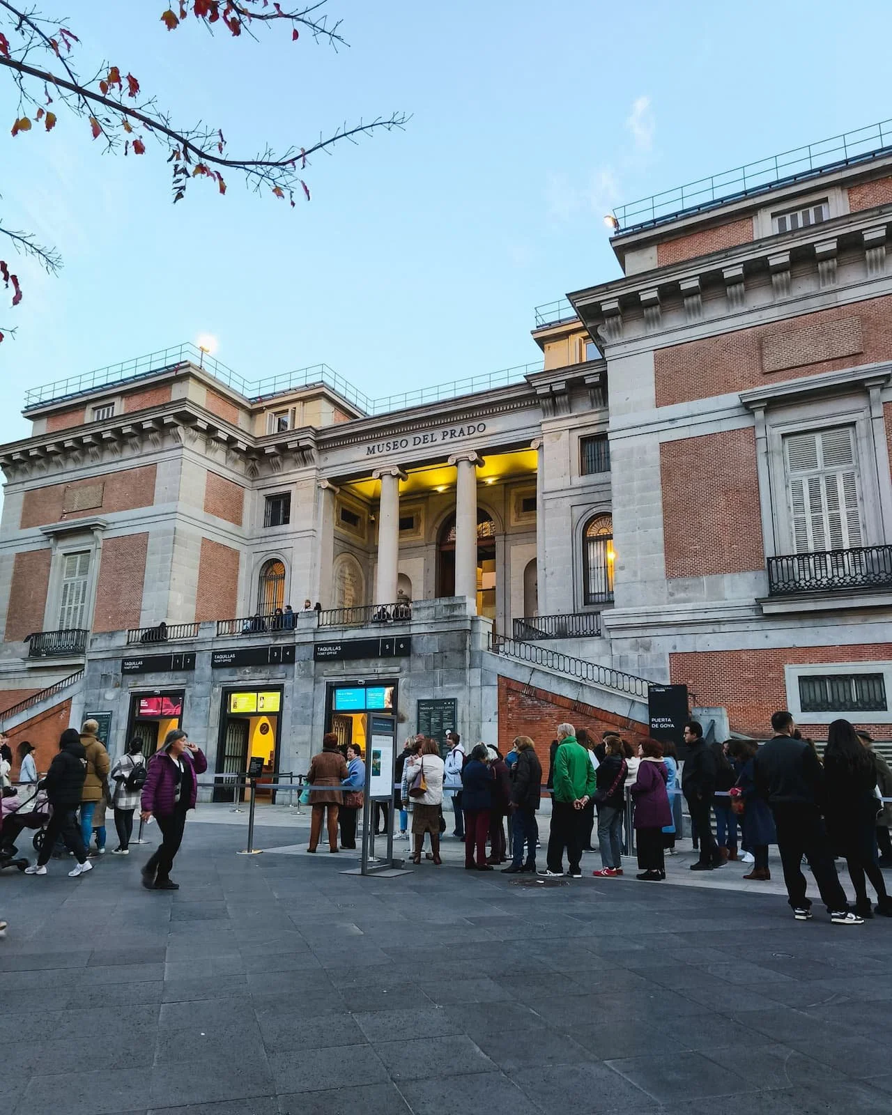 Exterior of the Prado Museum in Madrid with visitors near the entrance