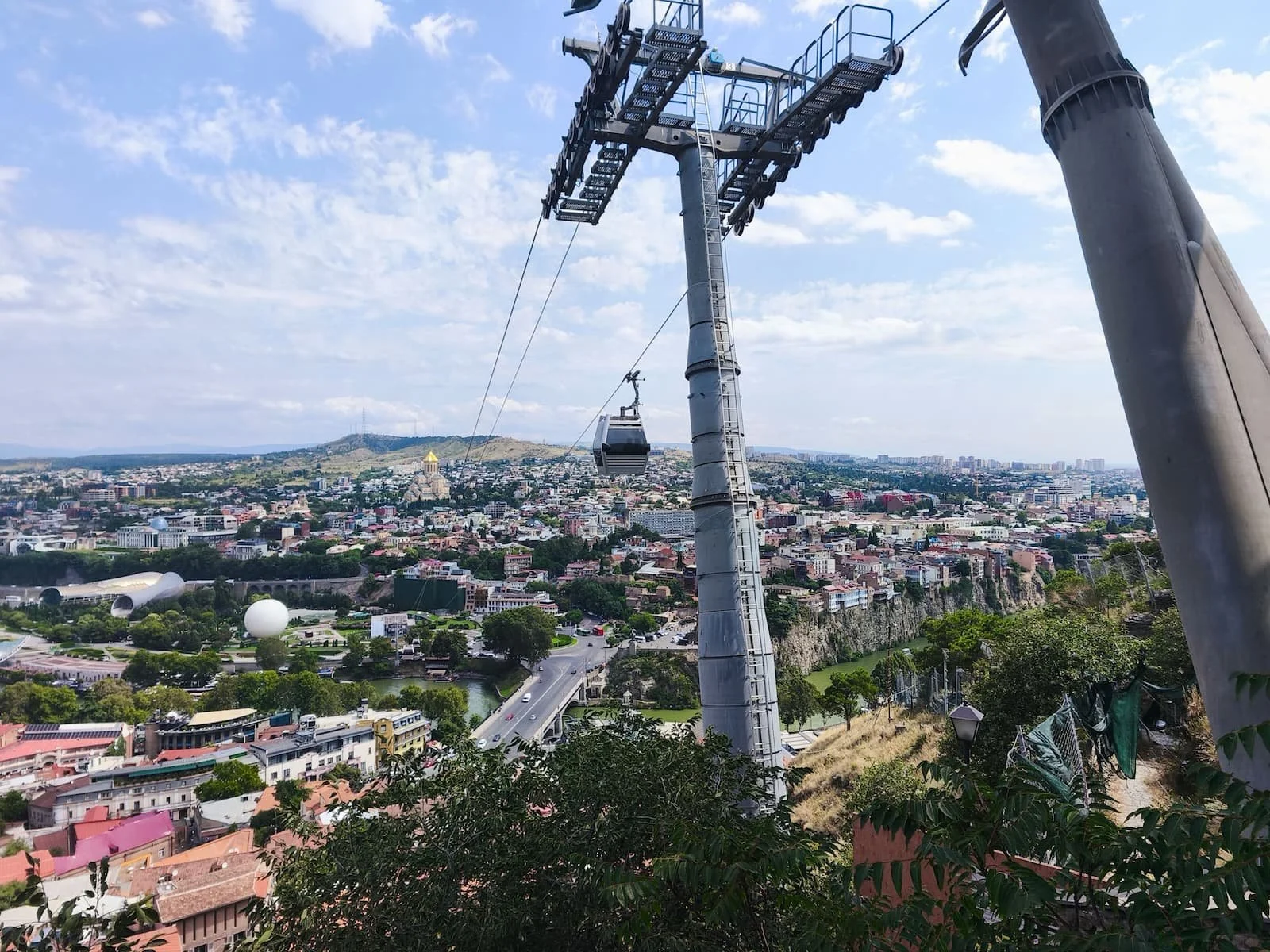 Panoramic view over Tbilisi from Narikala with the cable car in the foreground