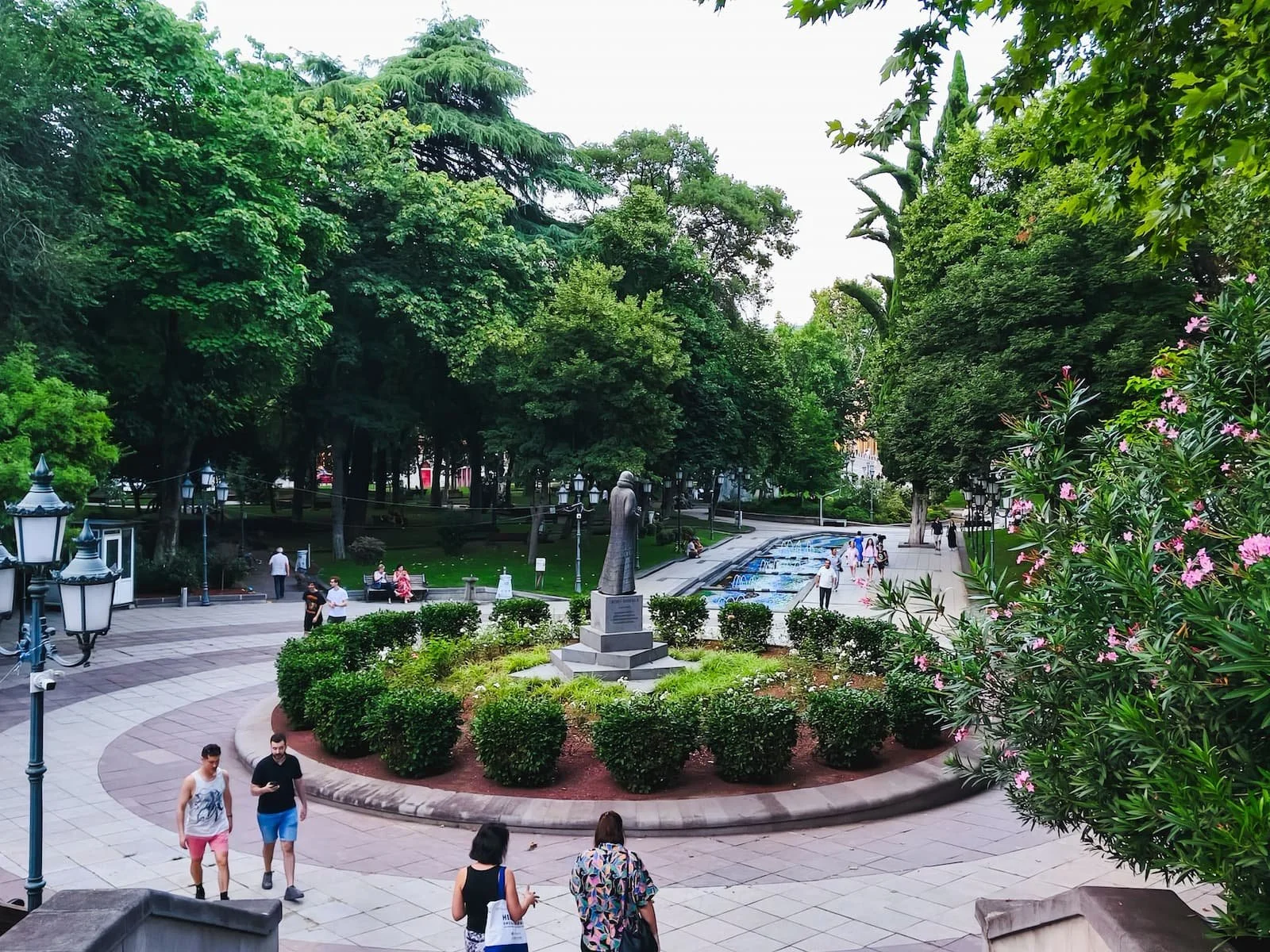 9 April Park in central Tbilisi with trees, paths, and surrounding city buildings