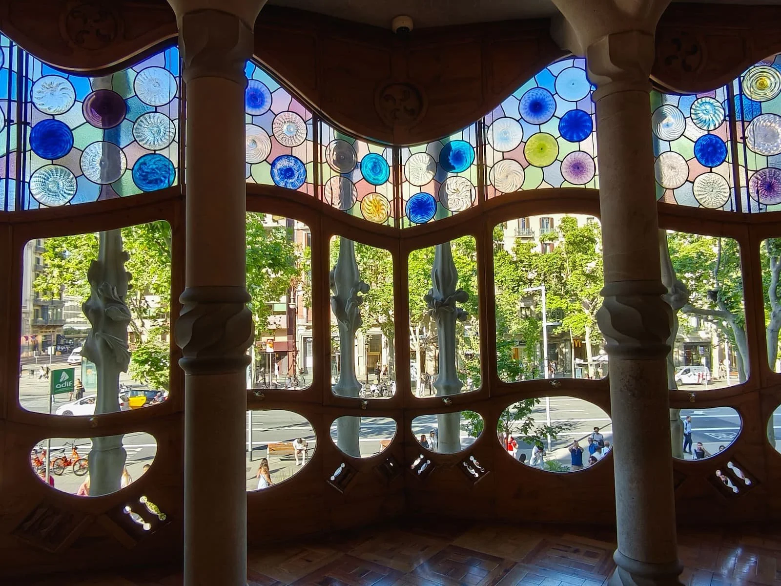 Curved interior window with colorful circular glass panes inside Casa Batlló