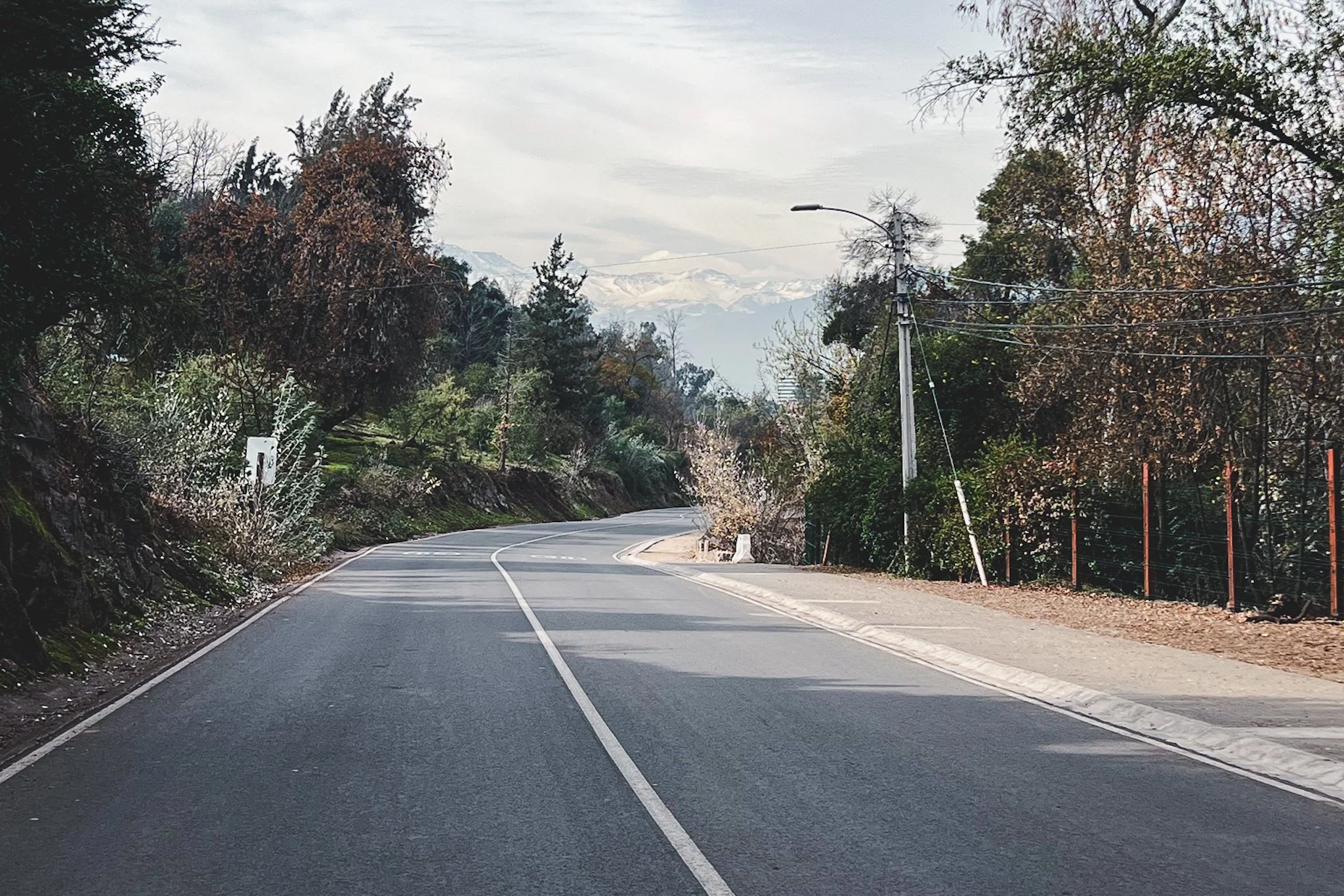 Wide paved path inside Metropolitan Park of Santiago.