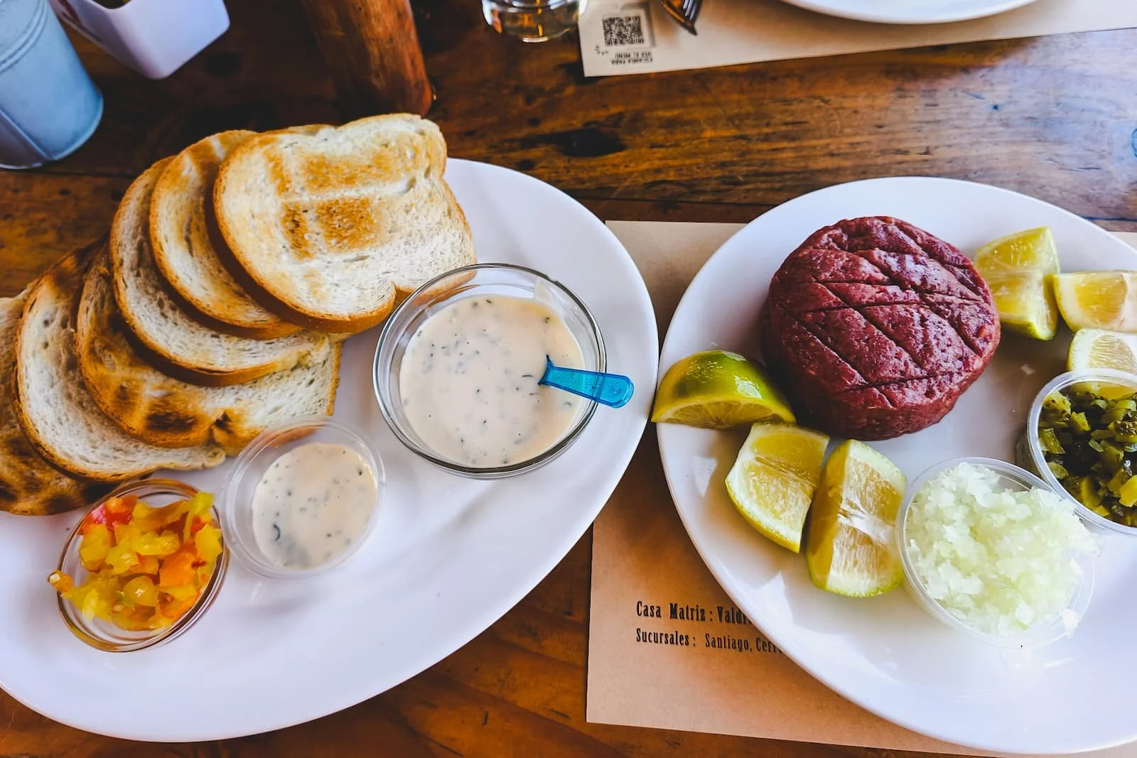 Crudo served with bread and condiments at Café Hausmann in Valdivia, Chile.