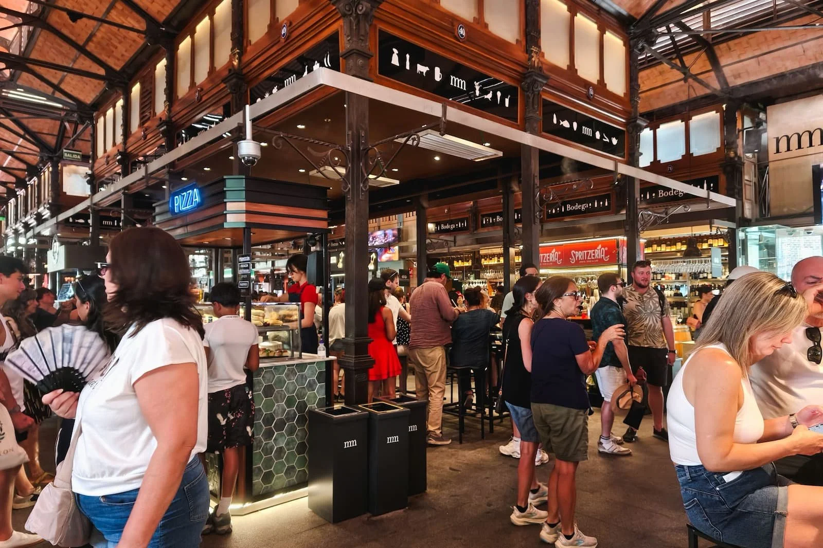 Crowded food stalls inside Mercado de San Miguel in Madrid.
