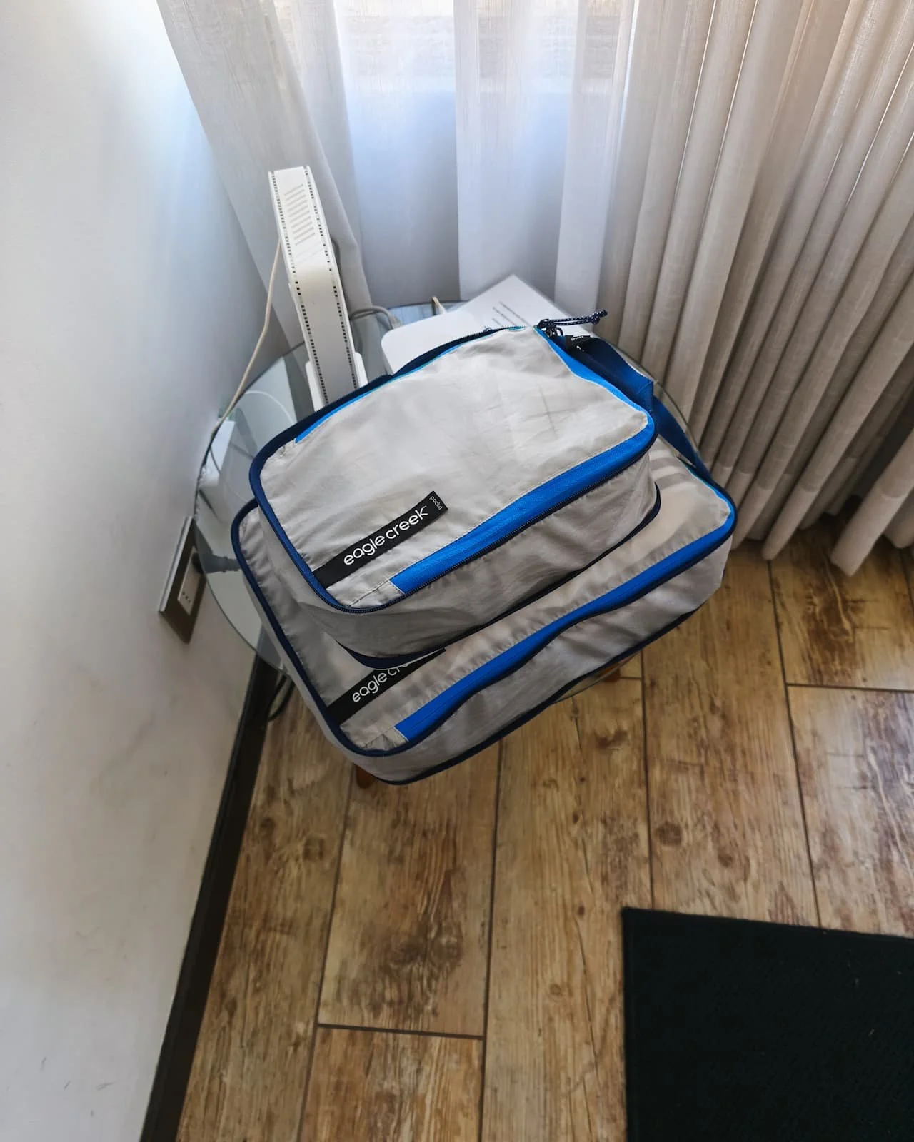Packing cubes laid out as a portable clothing system while traveling.