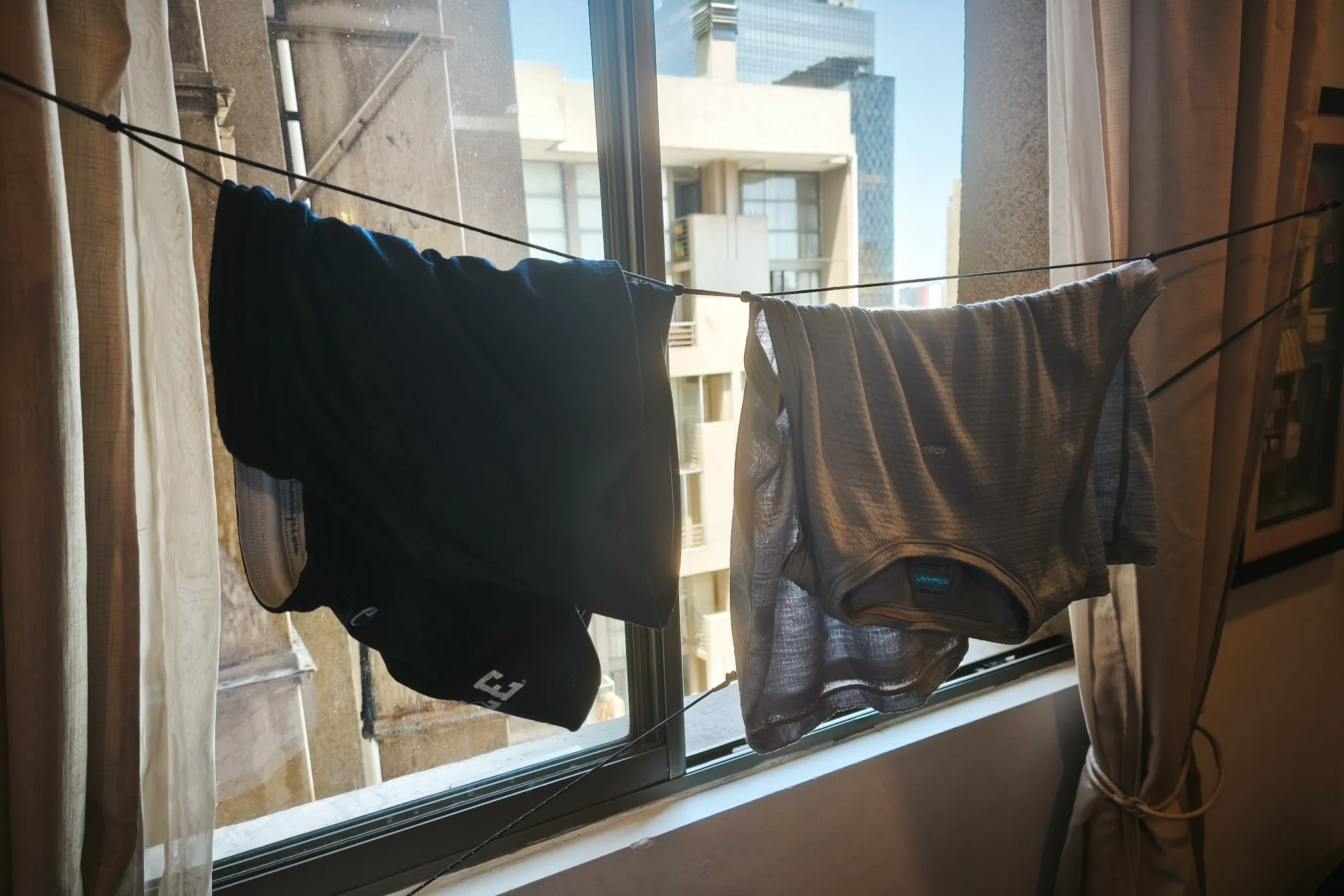 Laundry hanging to dry inside an apartment during a longer trip.