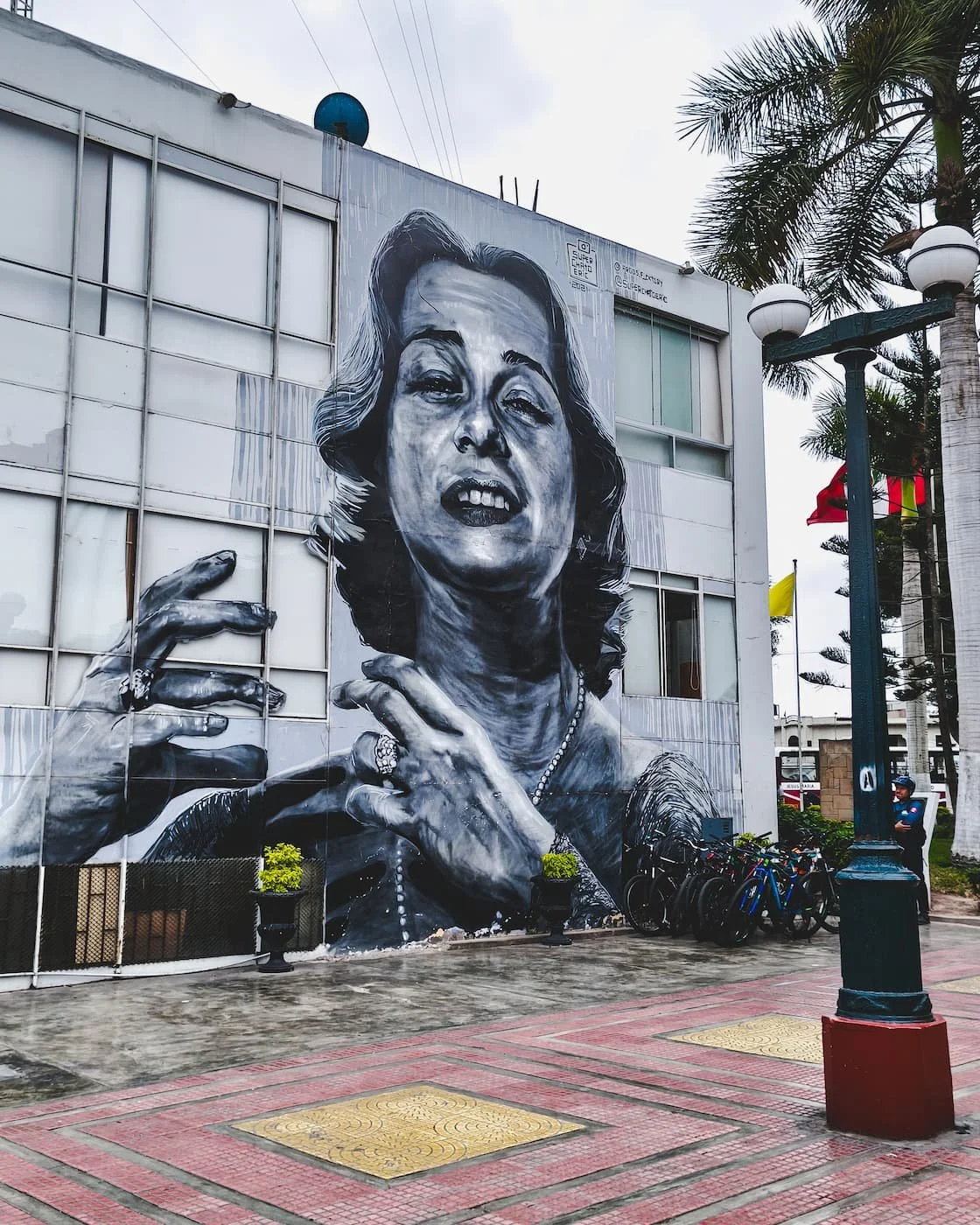 Mural in plaza near Bridge of Sighs, featuring a black-and-white image of a woman.