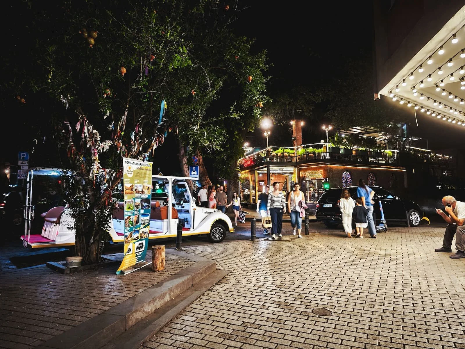 Lively streets of Old Tbilisi at night with restaurants and people outside