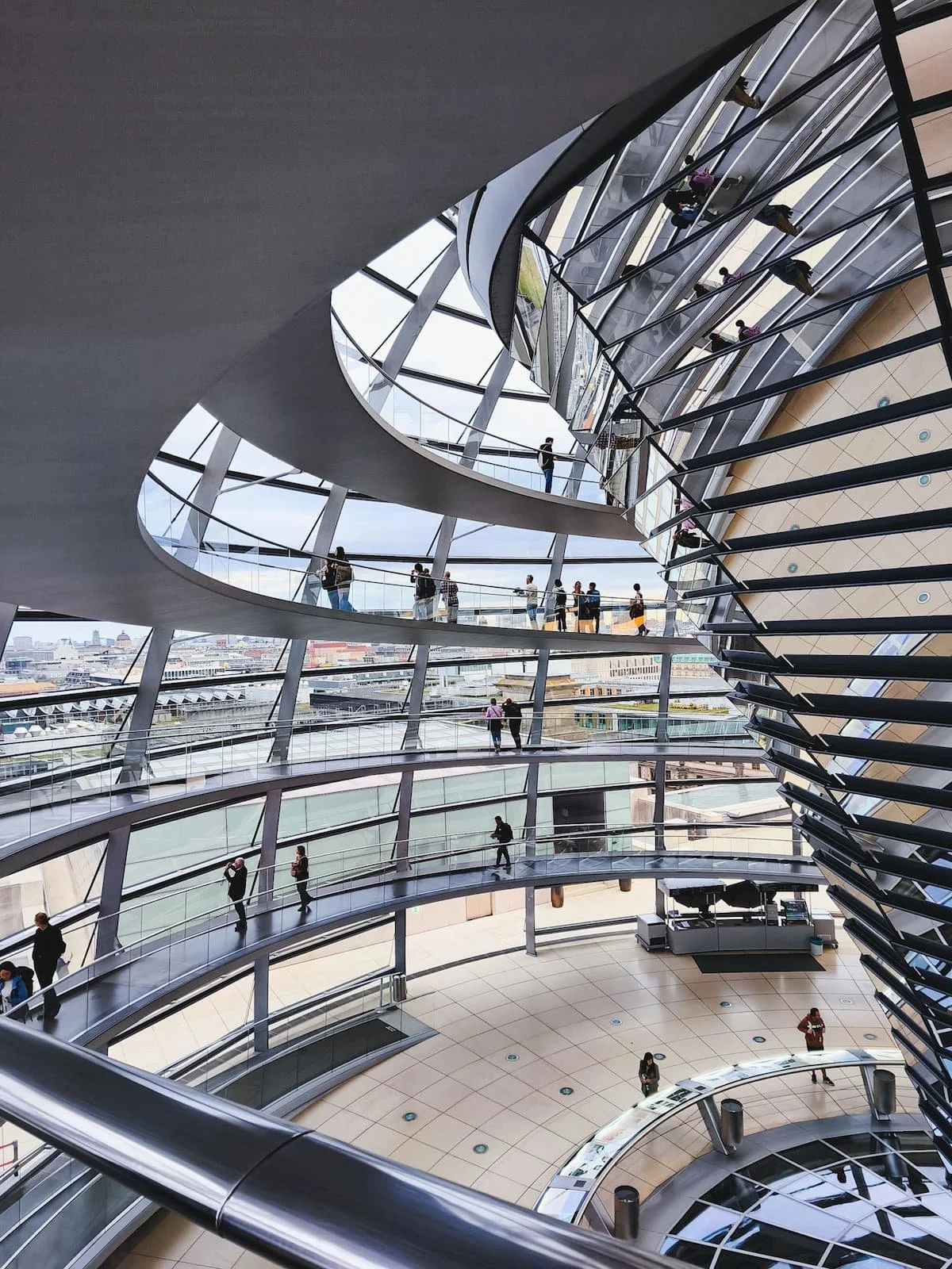Interior of the Reichstag's glass dome, with curved walkways and views over Berlin.