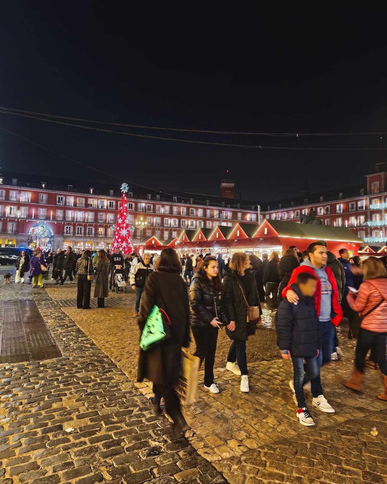 Plaza Mayor in Madrid during the Christmas market season at night.