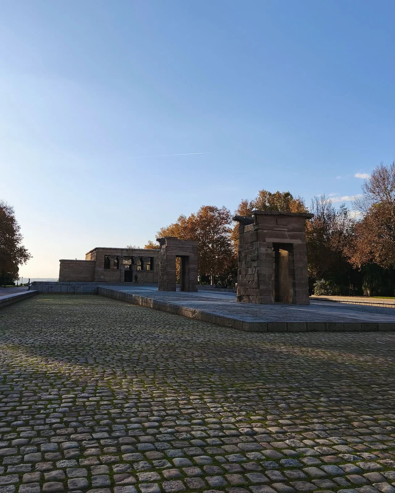 Templo de Debod at the end of a wide cobblestone path in Madrid