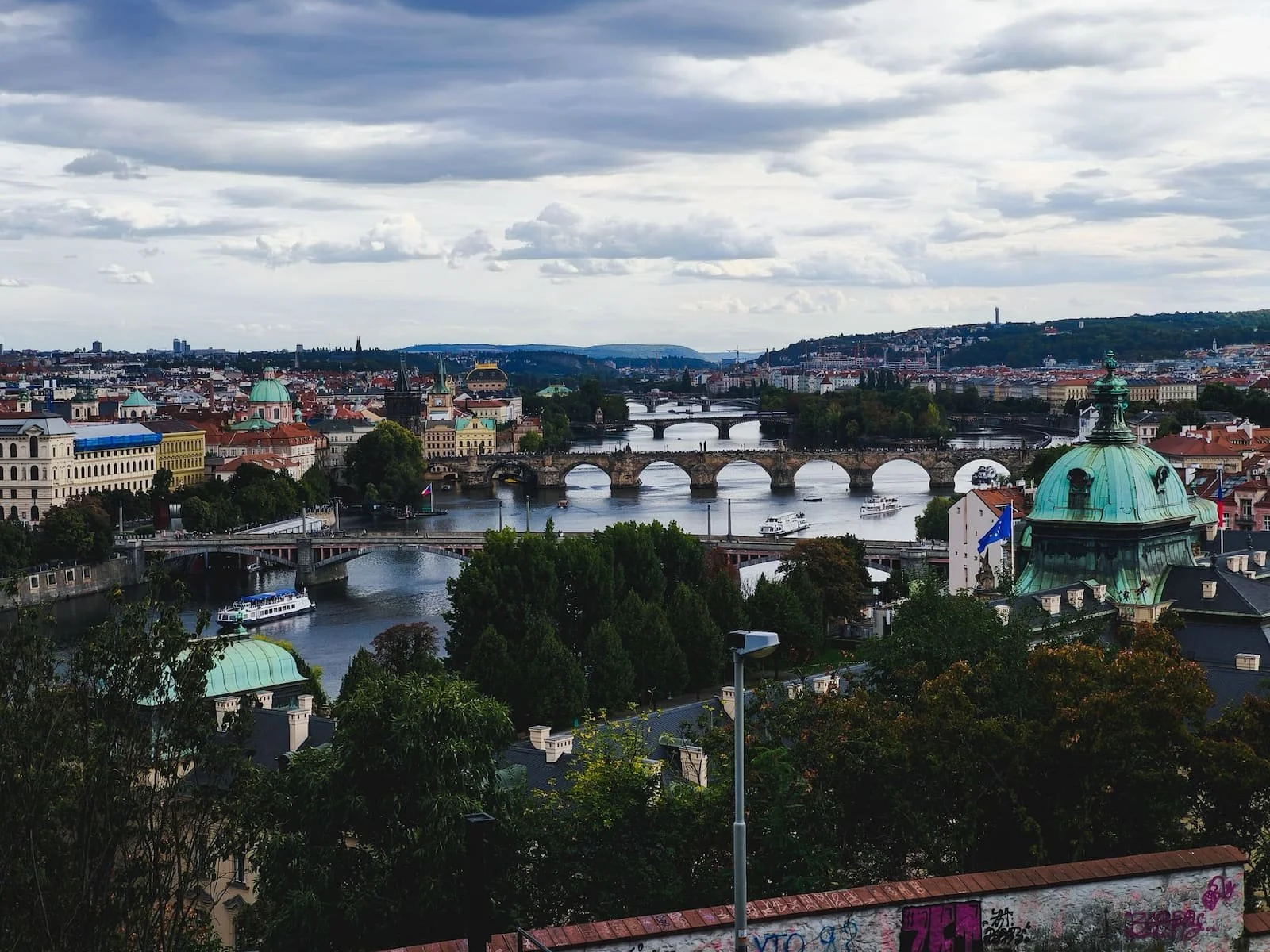 Elevated view from Letná Park showing several bridges crossing the Vltava River through central Prague.
