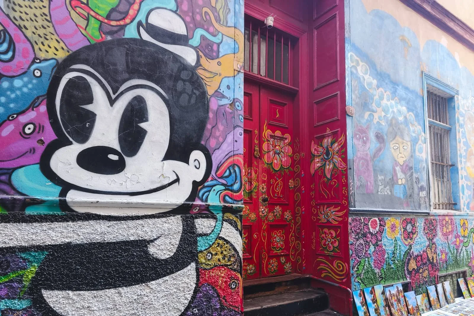 Red-painted doorway and colorful walls in Cerro Concepción in Valparaíso.