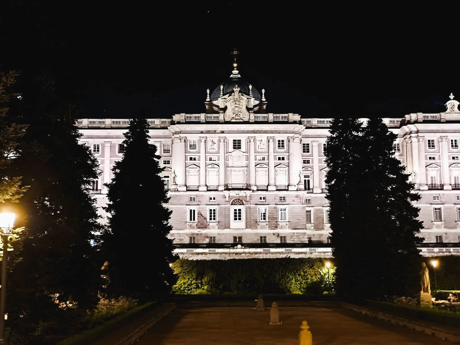 The Royal Palace of Madrid illuminated at night.