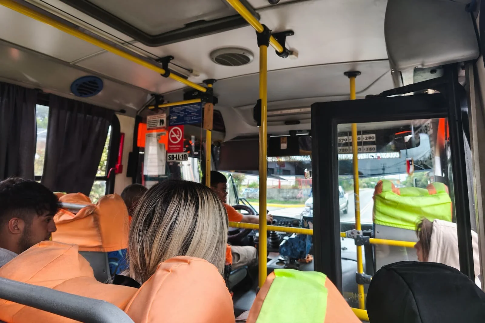 Interior of a local bus in Valdivia Chile with seated and standing passengers