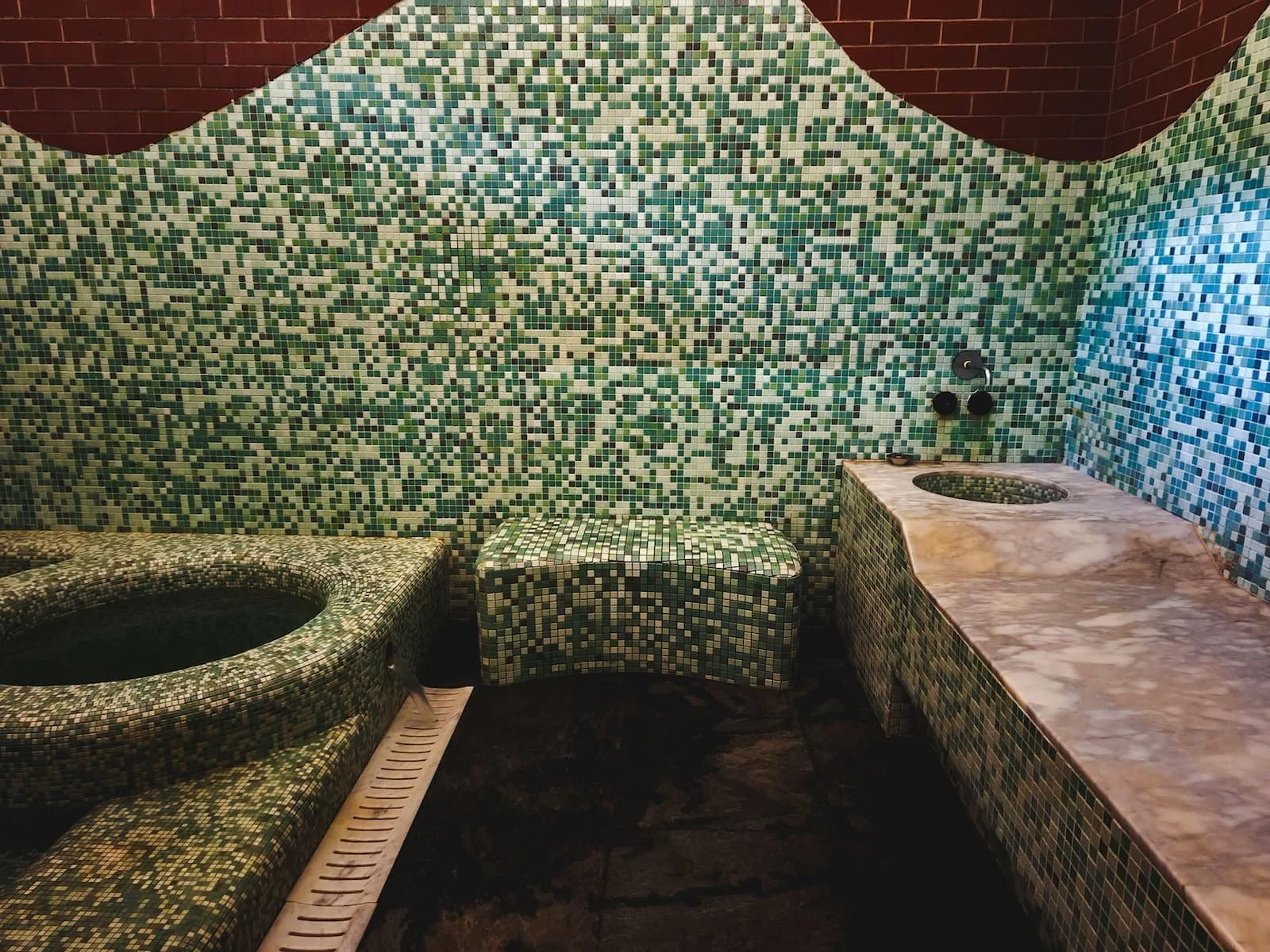 The pool area with stone massage table in Room 4 at Chreli Abano
