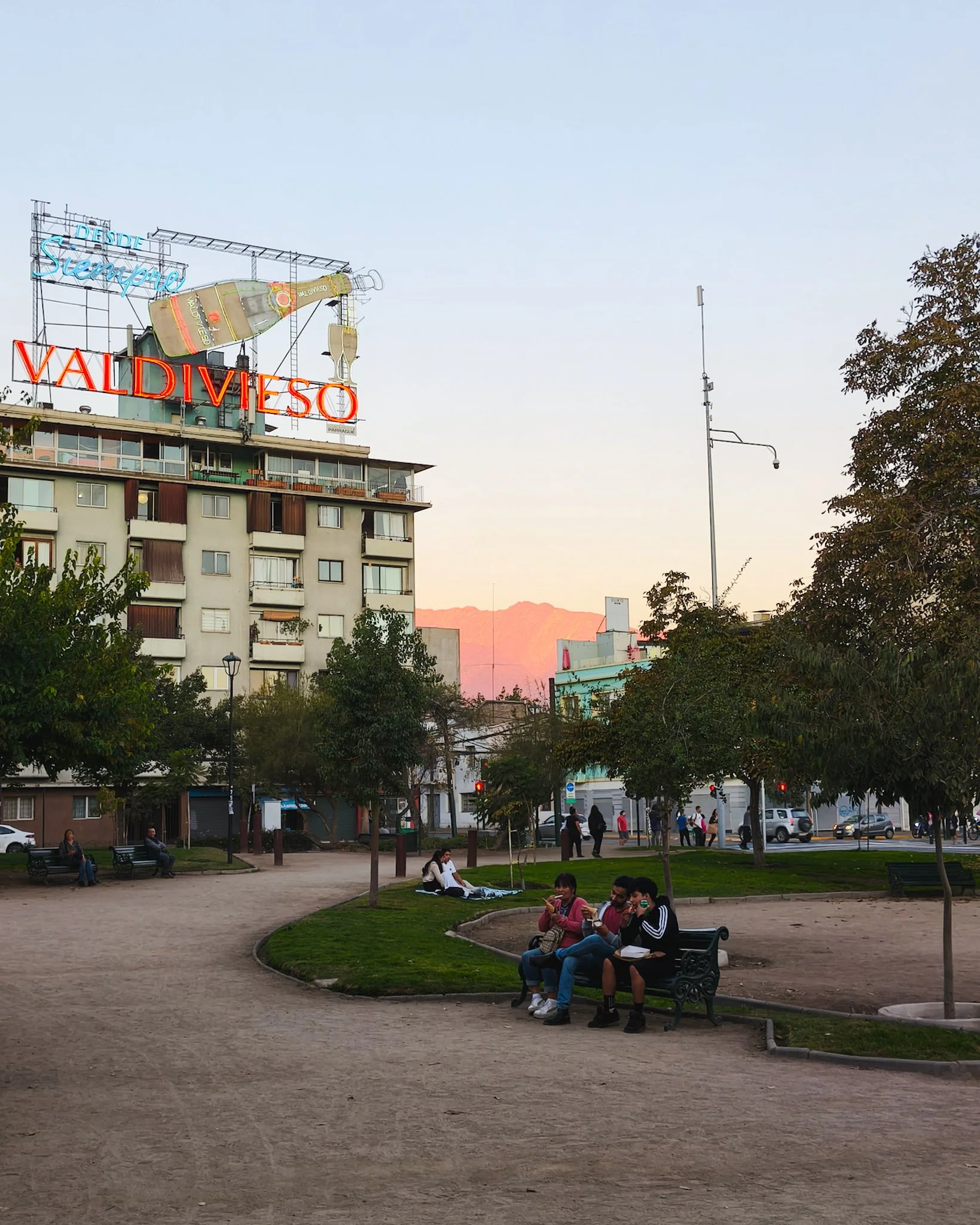 People relaxing in Parque Bustamante in Santiago, Chile during the evening.