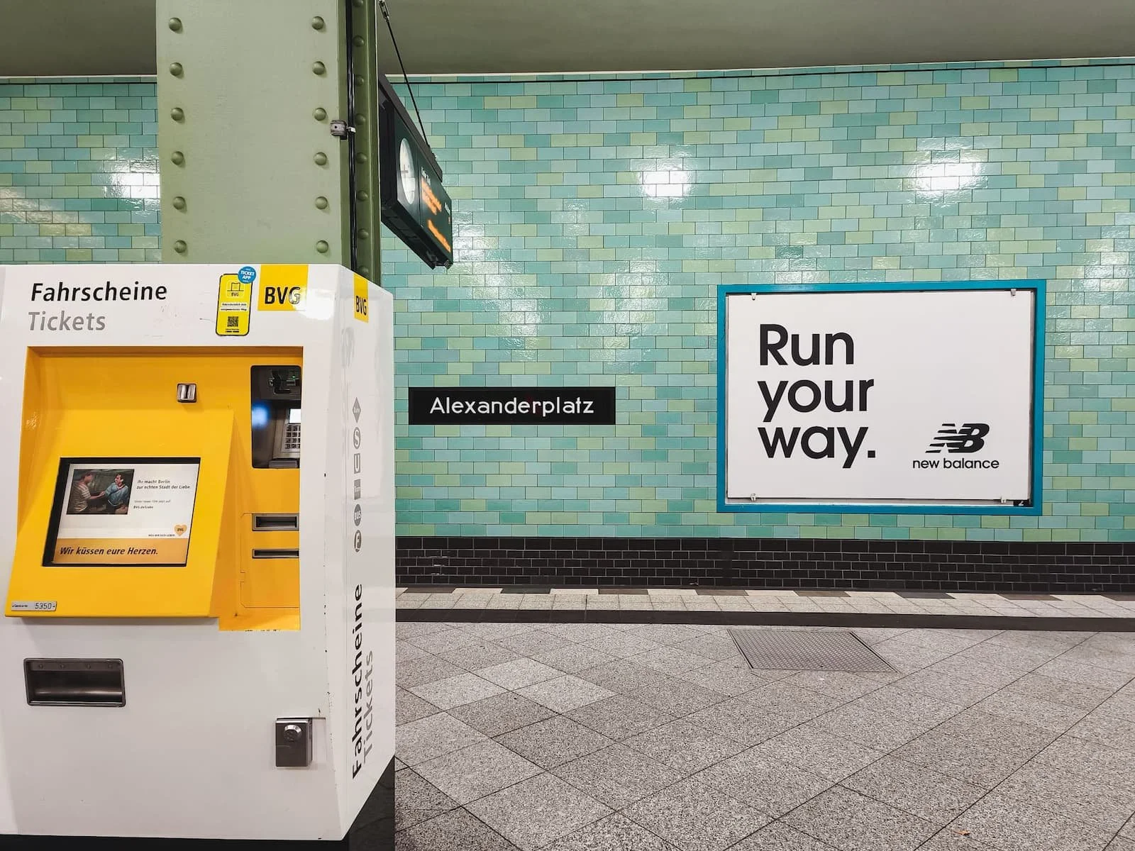 Yellow public transport ticket machine at Alexanderplatz U-Bahn station in Berlin.