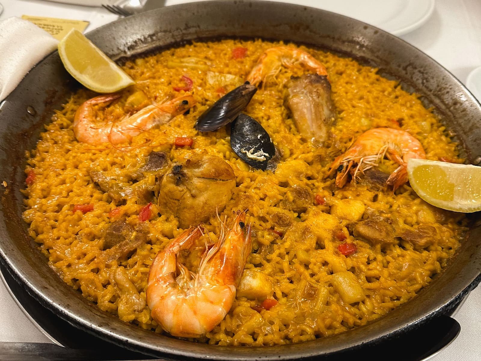 Paella served in a wide pan at Restaurante La Barraca in Madrid