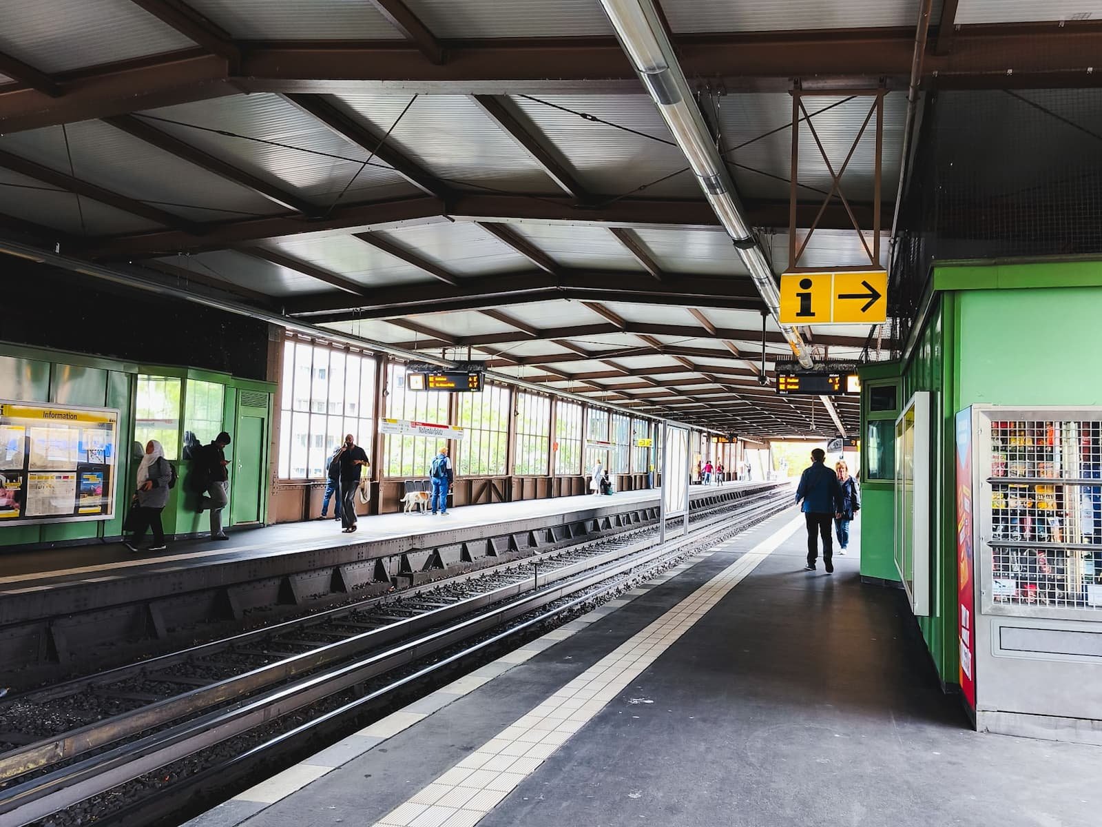 U-Bahn station platform near our accommodation in Berlin, with tiled flooring, tracks, and station signage.
