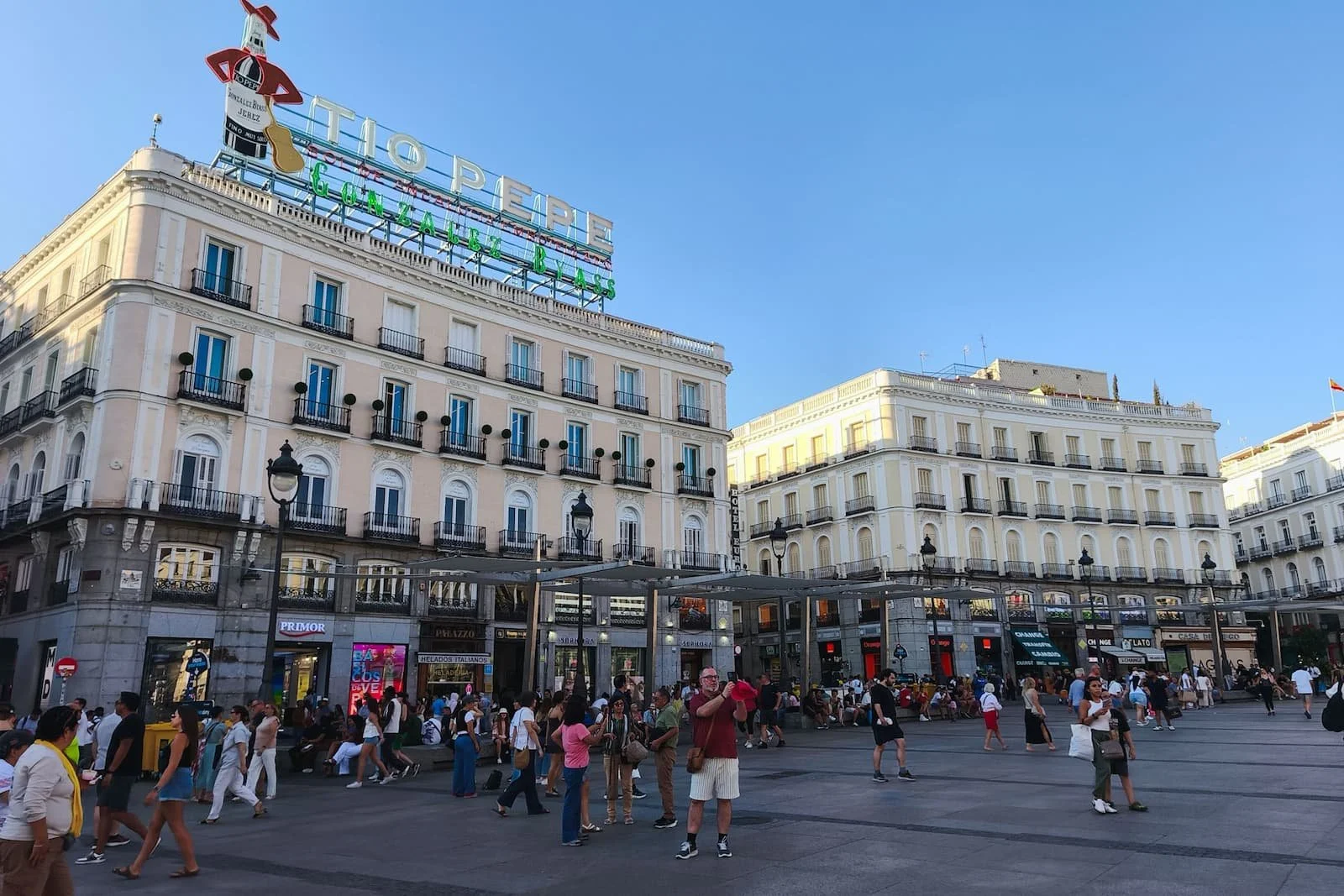 Puerta del Sol, one of Madrid’s main central squares, with crowds and the Tío Pepe sign.