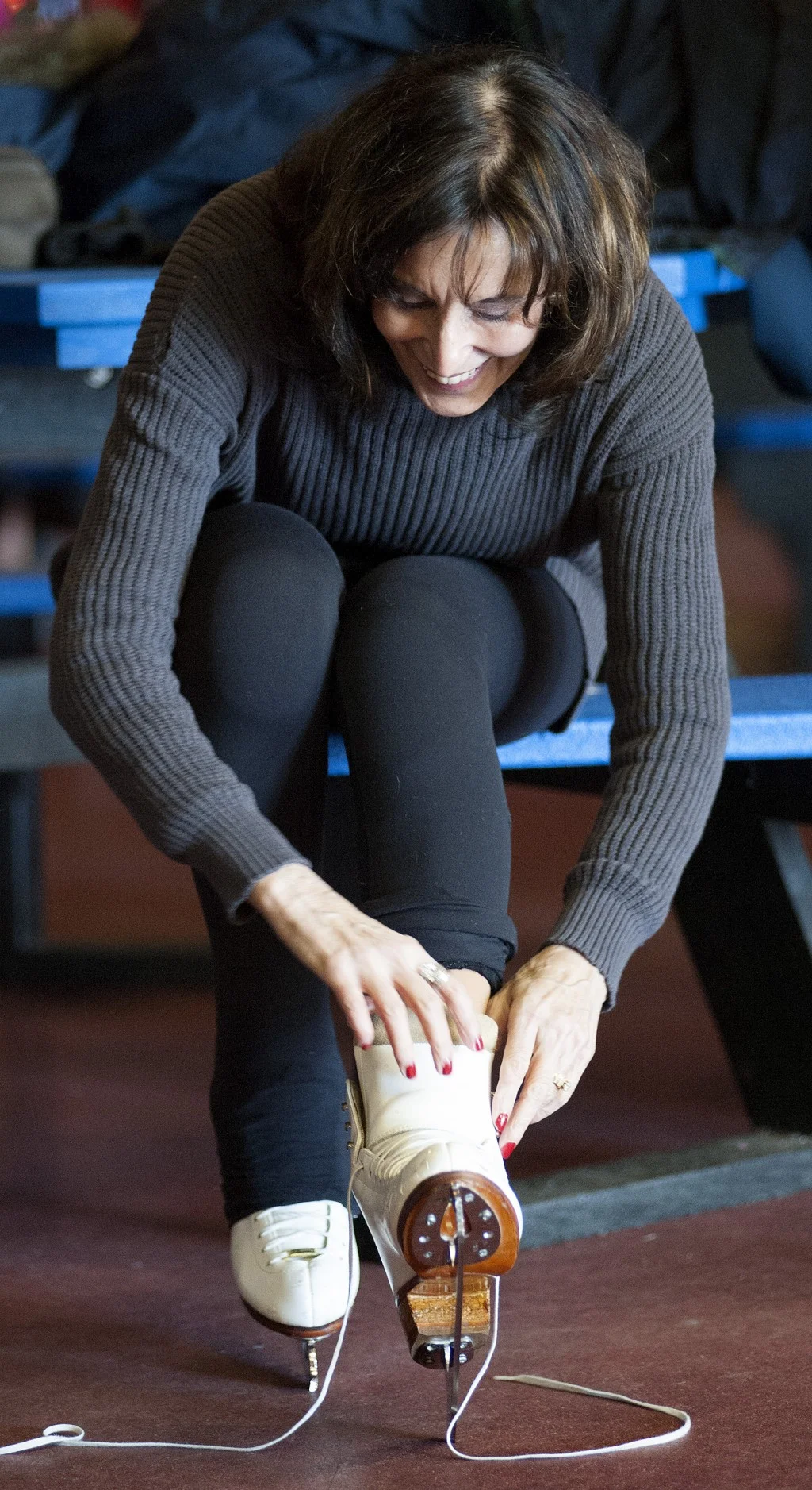 Author Jeanne Erdman laces up her skates before ice skating aerobics at the Hardee's Iceplex in Chesterfield, Mo. (Sid Hastings/For The Washington Post)