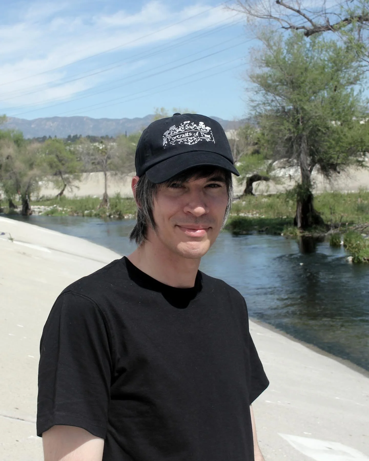 Portraits Of Past hats are now available in our merch store. Silver thread embroidered on a black cotton dad cap.

Ornate logo tees are back in stock too.

Matt along the Los Angeles River. March, 2026.

We love all of you.