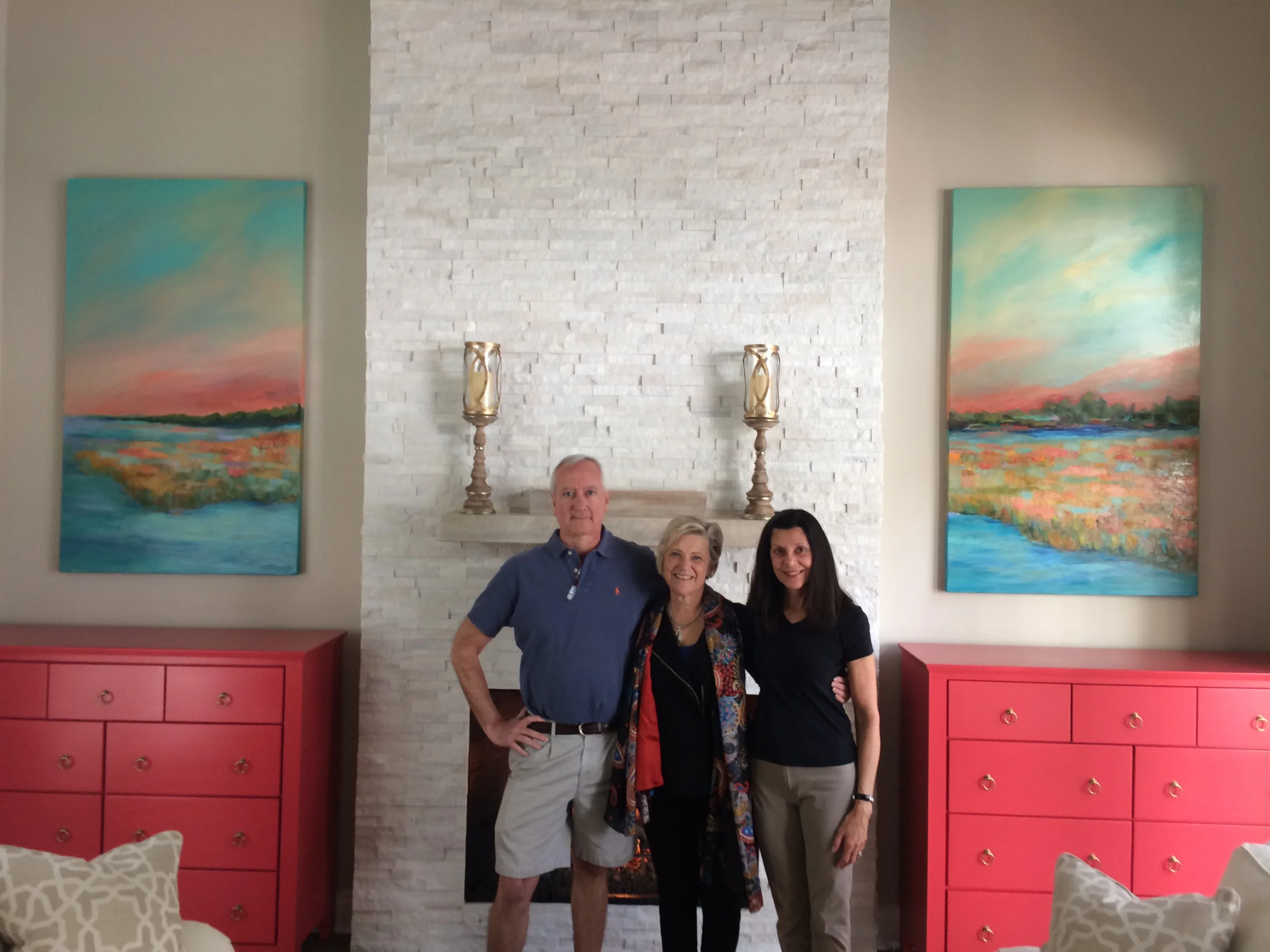 Cincinnati artist Trish Weeks celebrating a finished commissioned abstract landscape with clients.