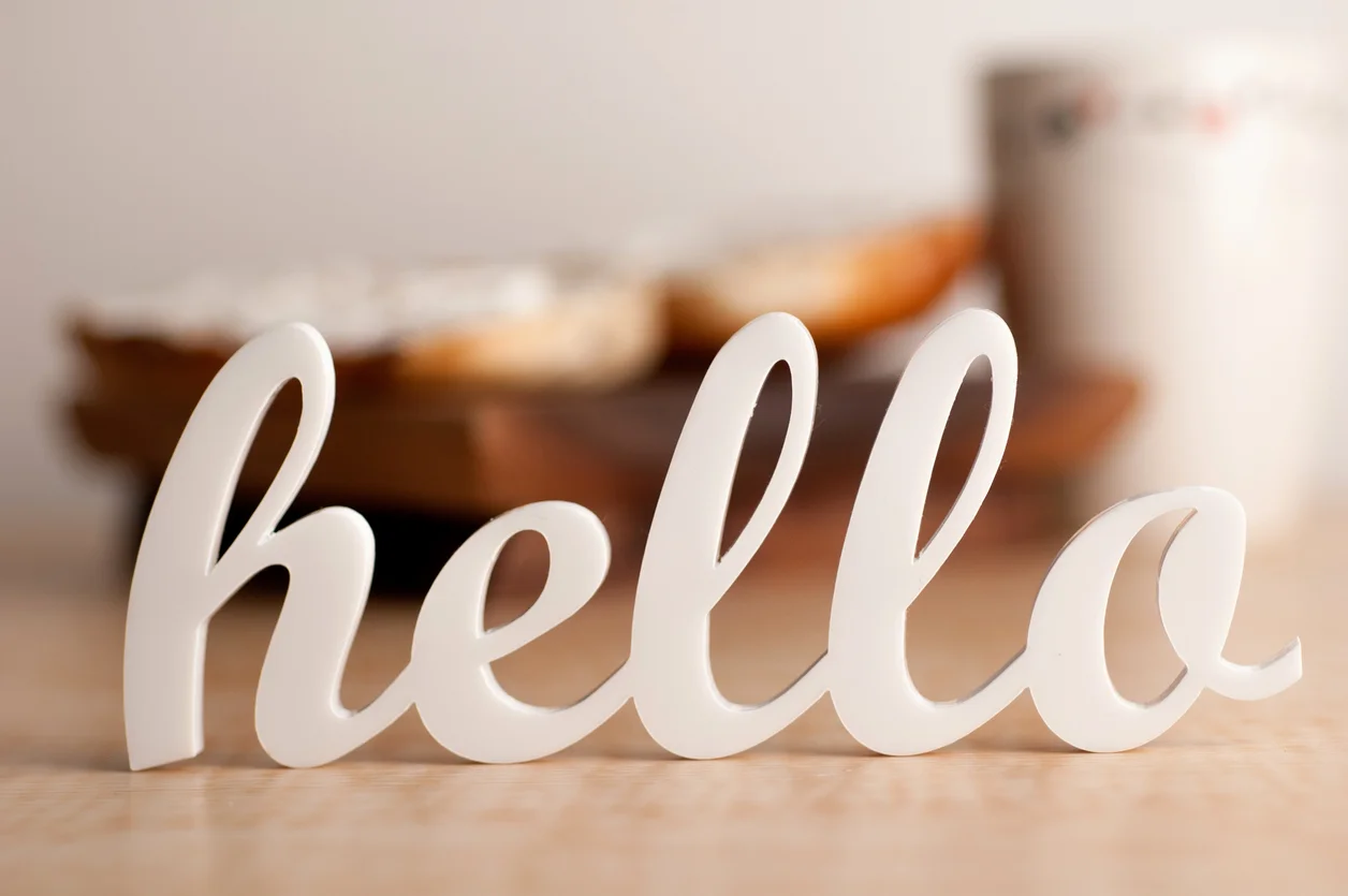 Cursive-hello-sign-with-blurred-breakfast-in-background-147518752_1257x836.jpeg