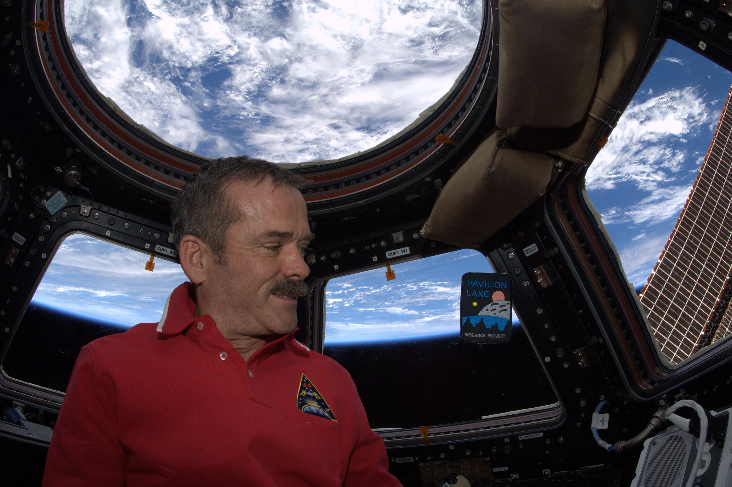 Col. Chris Hadfield and a floating PLRP badge in space