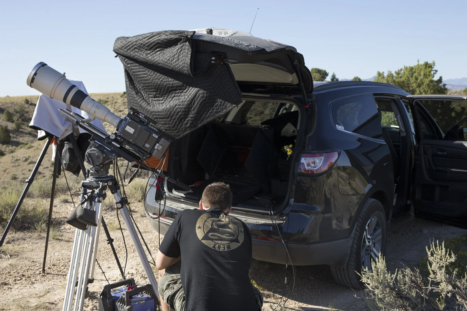 Keeping things cool is a big issue when shooting in desert locations like this one in the Mojave Desert outside Barstow, CA in July, 2015. My Phantom Flex 4K technician, Matt Drake, does some final checks while we wait on the station to show up.