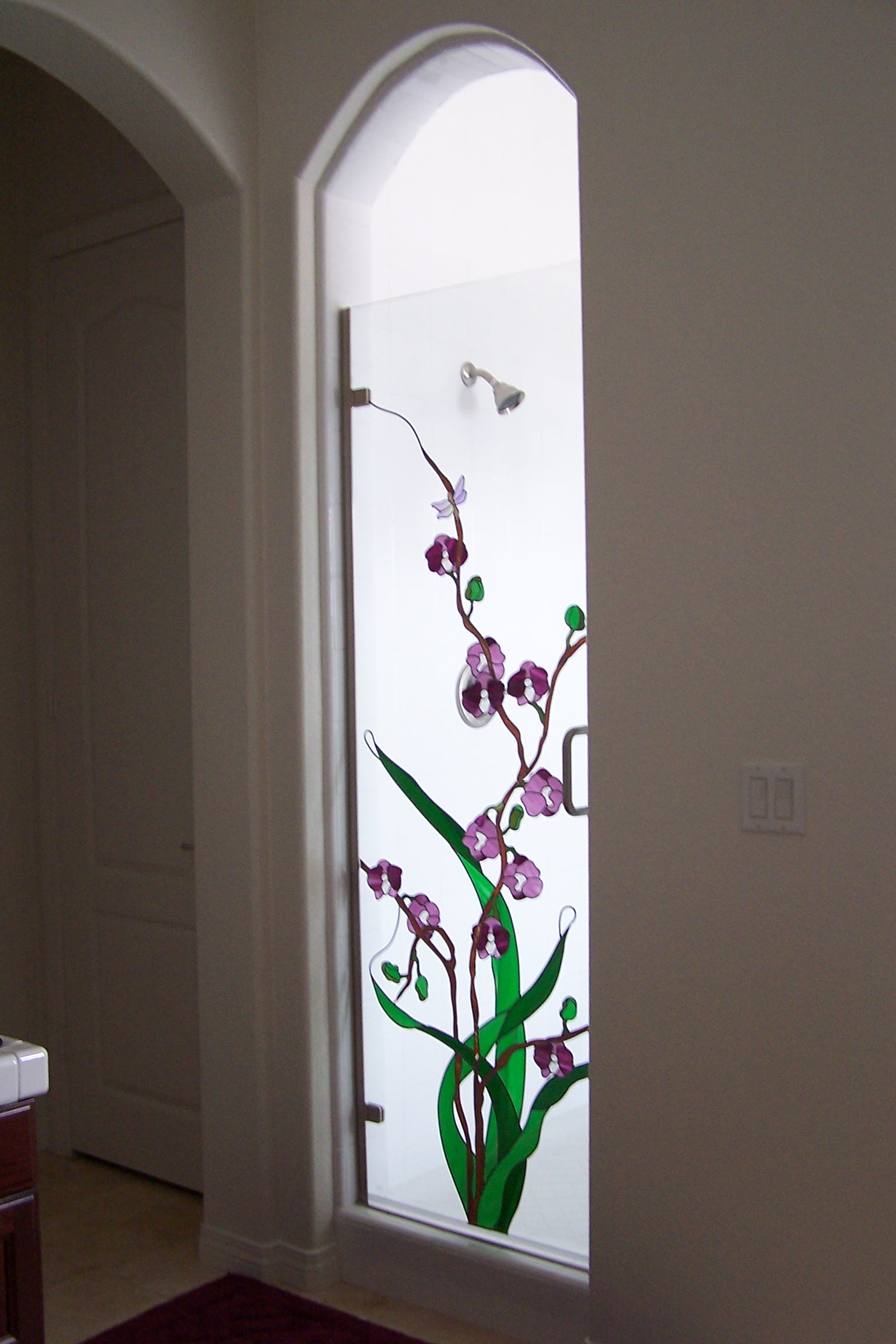 Arched window glass with purple flowers