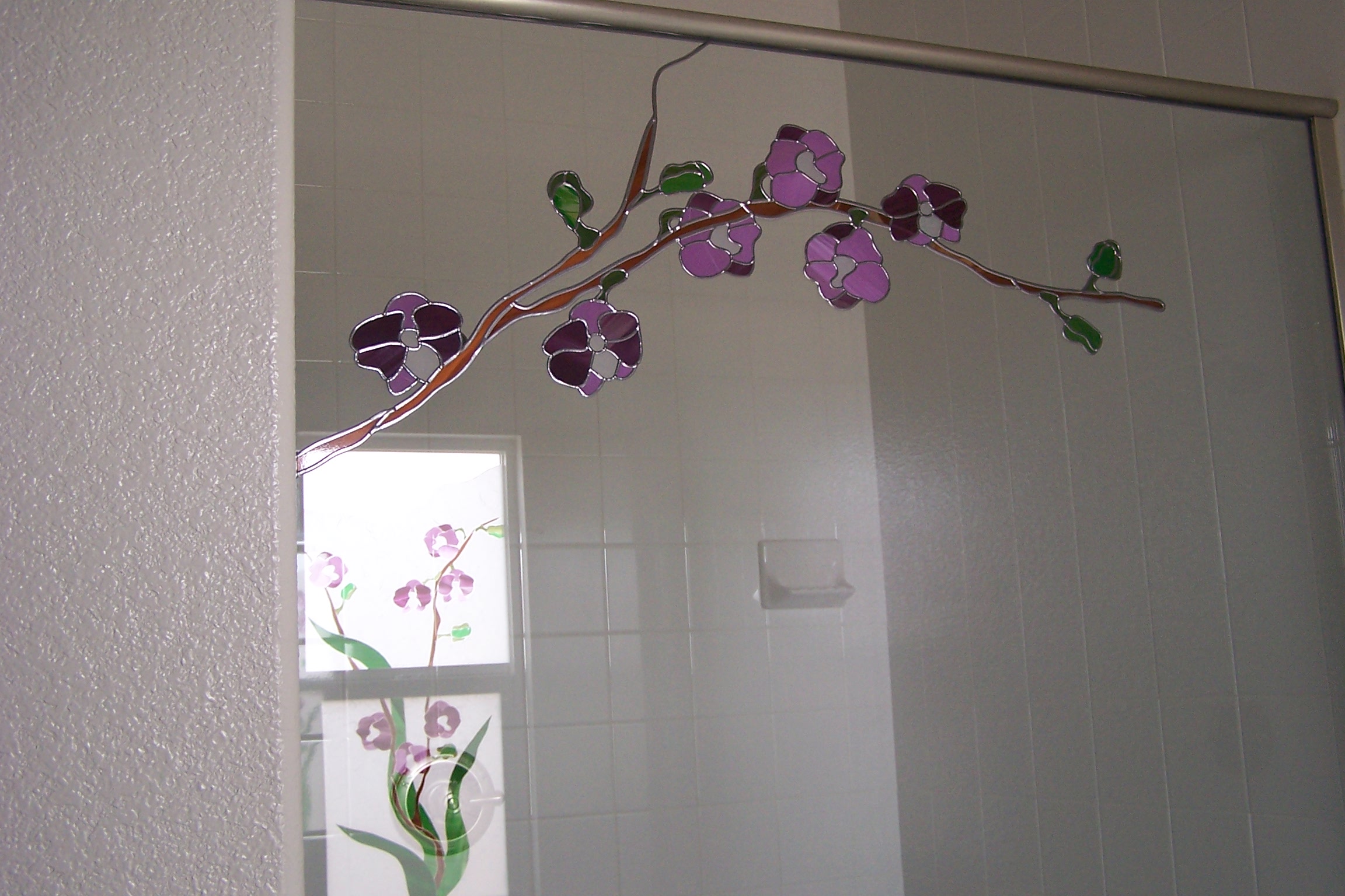 Purple flowers on clear tempered shower door