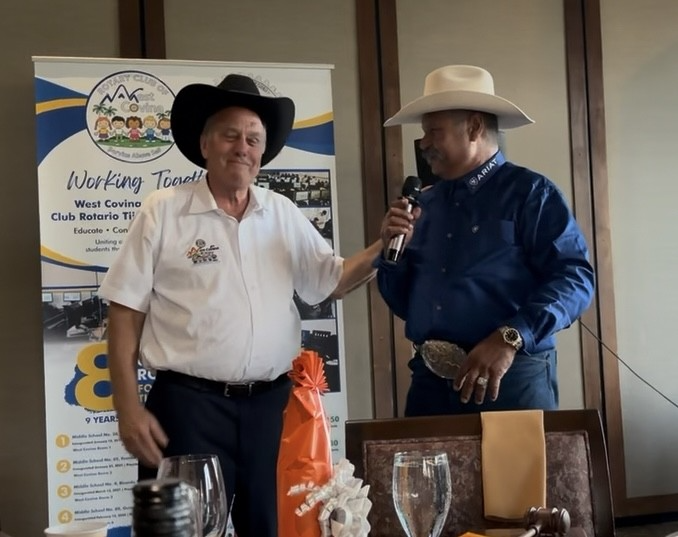 Frank Leyva of Ridge Riders Equestrians presents outgoing WC Rotary Club President David Carmany a Stetson.png