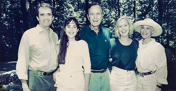 Bill Reilly and President George H.W. Bush posing at Camp David with Reilly's daughters, Megan and Katherine, and Reilly's wife, Libbie. Reilly/White House photo