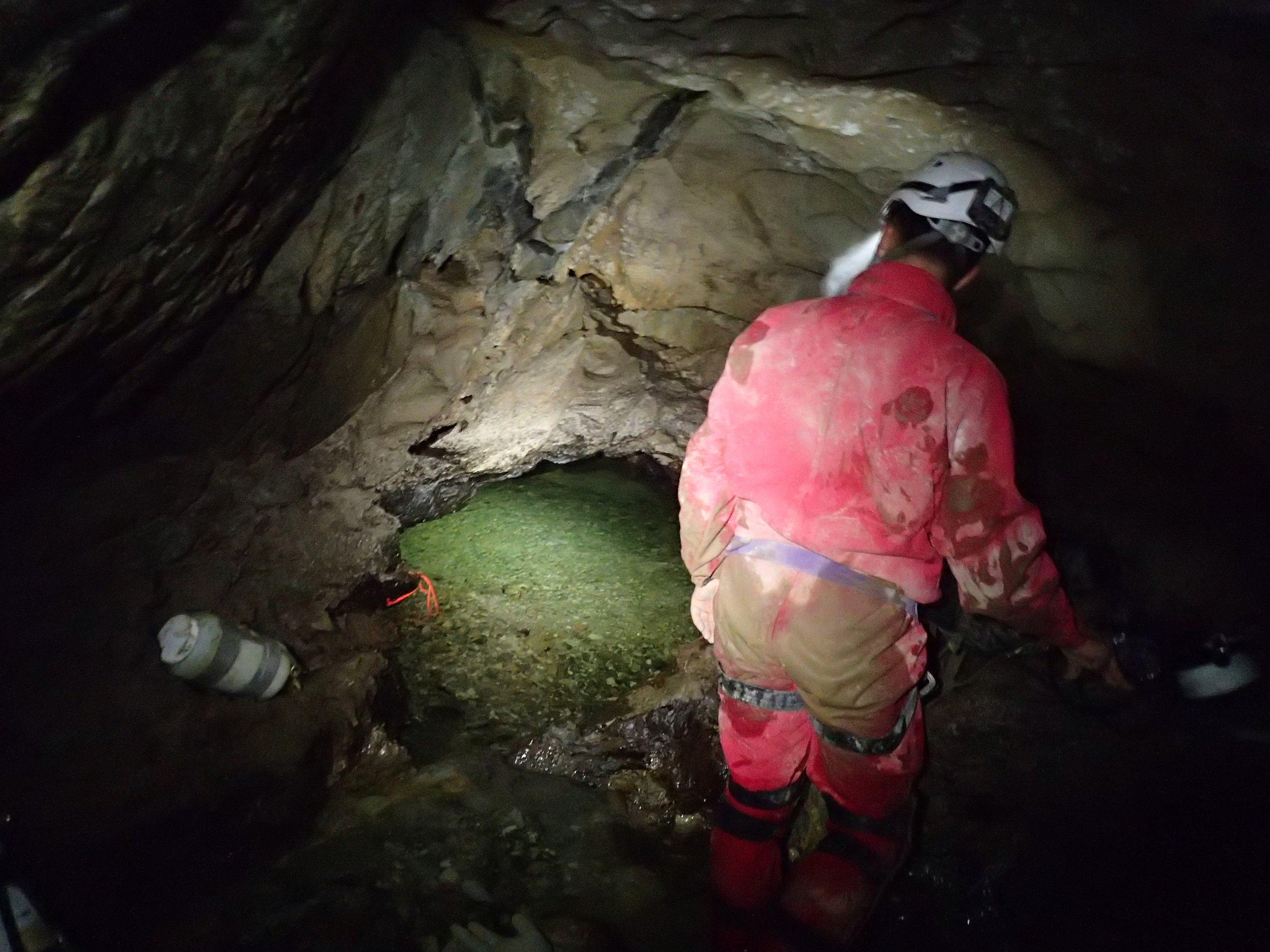 Jason Richards looks into Sump 1 at Whistling Cave, BC